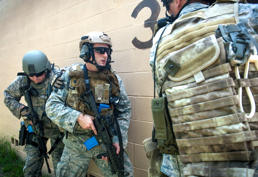 U.S. Air Force Staff Sgts. Marc Robinson, left, 23d Security Forces Squadron unit trainer, and Joseph Overholt, 23d SFS unit training manager, stack up for a shoot-don’t-shoot evaluation at Moody Air Force Base, Ga., Sept. 6, 2013. The evaluation was part of tryouts for the Special Reaction Team, a team that trains to intervene in hostage situations, provide security for distinguished visitors, and high-risk arrests. (U.S. Air Force photo by Senior Airman Jarrod Grammel/Released)
