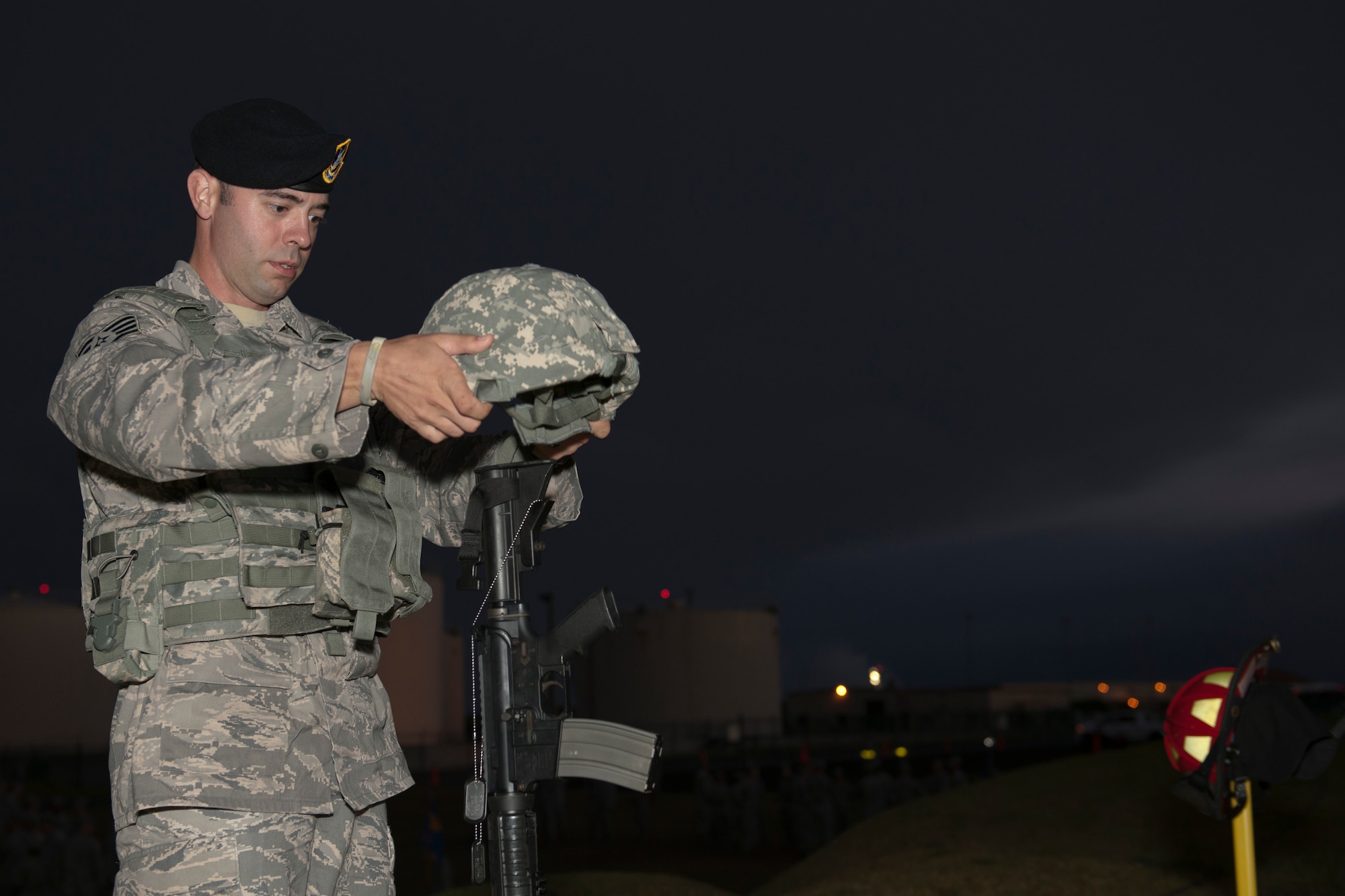 U.S. Air Force Staff Sgt. Zackery Vaught, 65th Security Forces Squadron specialist, assembles a memorial during a 9/11 remembrance ceremony Sept. 11, 2013, at Lajes Field, Azores. The 65th Air Base Wing honored those killed on 9/11 with a “boots and utes” memorial run that was led by Lajes Airmen first responders. (U.S. Air Force photo by Tech. Sgt. Paul Villanueva II/Released)