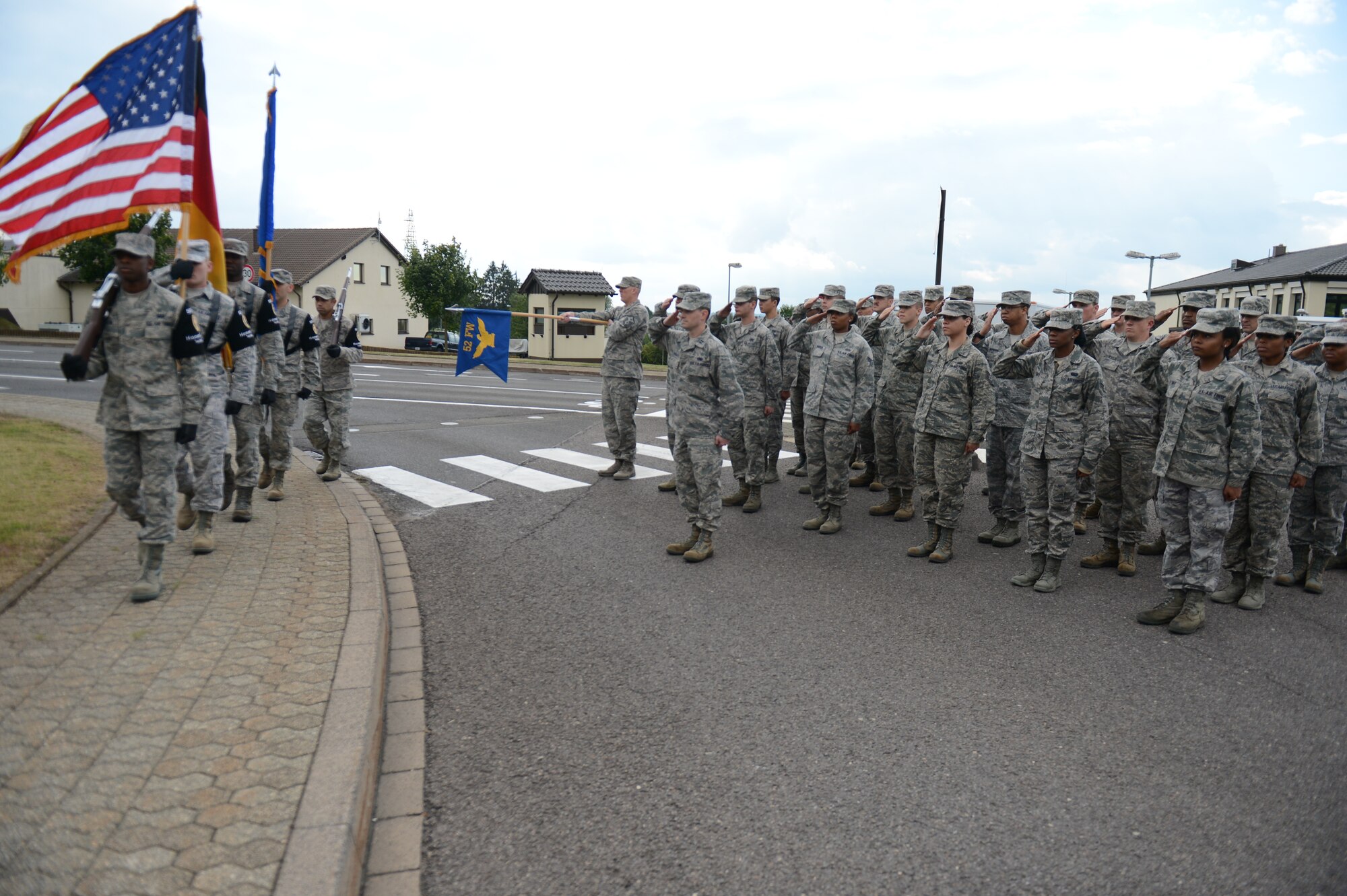 SPANGDAHLEM AIR BASE, Germany – The 52nd Force Support Squadron Honor Guard team march in front of a formation of Airmen during a 9/11 commemorative ceremony Sept. 11, 2013. A few hundred Airman and local area leaders attended the ceremony at the Spangdahlem Air Park Memorial. (U.S. Air Force photo by Airman 1st Class Gustavo Castillo/Released)