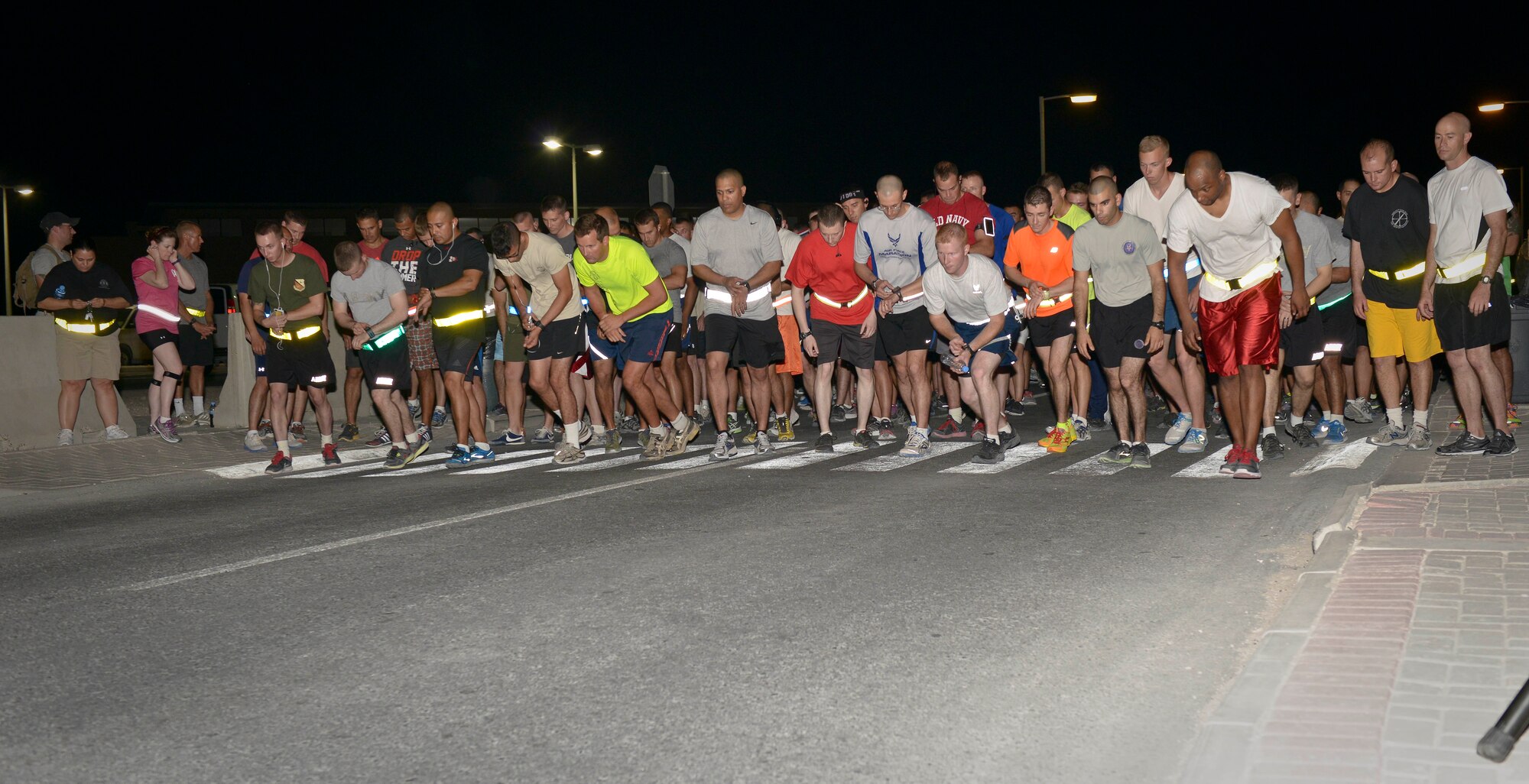 Runners begin at the 9/11 Memorial 5K at the 379th Air Expeditionary Wing in Southwest Asia, Sept. 11, 2013. More than 430 service members came out for the run commemorating all the lives lost in the attacks on the World Trade Center, the Pentagon, the fields of Shanksville, Penn., and since then on the battlegrounds of Iraq and Afghanistan. (U.S. Air Force photo/Staff Sgt. Benjamin W. Stratton)