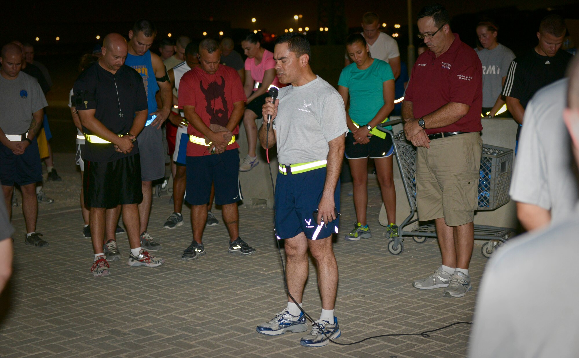 Chaplain (Maj.) Ismael Rodriguez leads runners in prayer prior to the start of the 9/11 Memorial 5K at the 379th Air Expeditionary Wing in Southwest Asia, Sept. 11, 2013. More than 430 service members came out for the run commemorating all the lives lost in the attacks on the World Trade Center, the Pentagon, the fields of Shanksville, Penn., and since then on the battlegrounds of Iraq and Afghanistan. Rodriguez is the 379th AEW deputy wing chaplain deployed from Moody Air Force Base, Ga., and a San Antonio native. (U.S. Air Force photo/Staff Sgt. Benjamin W. Stratton)
