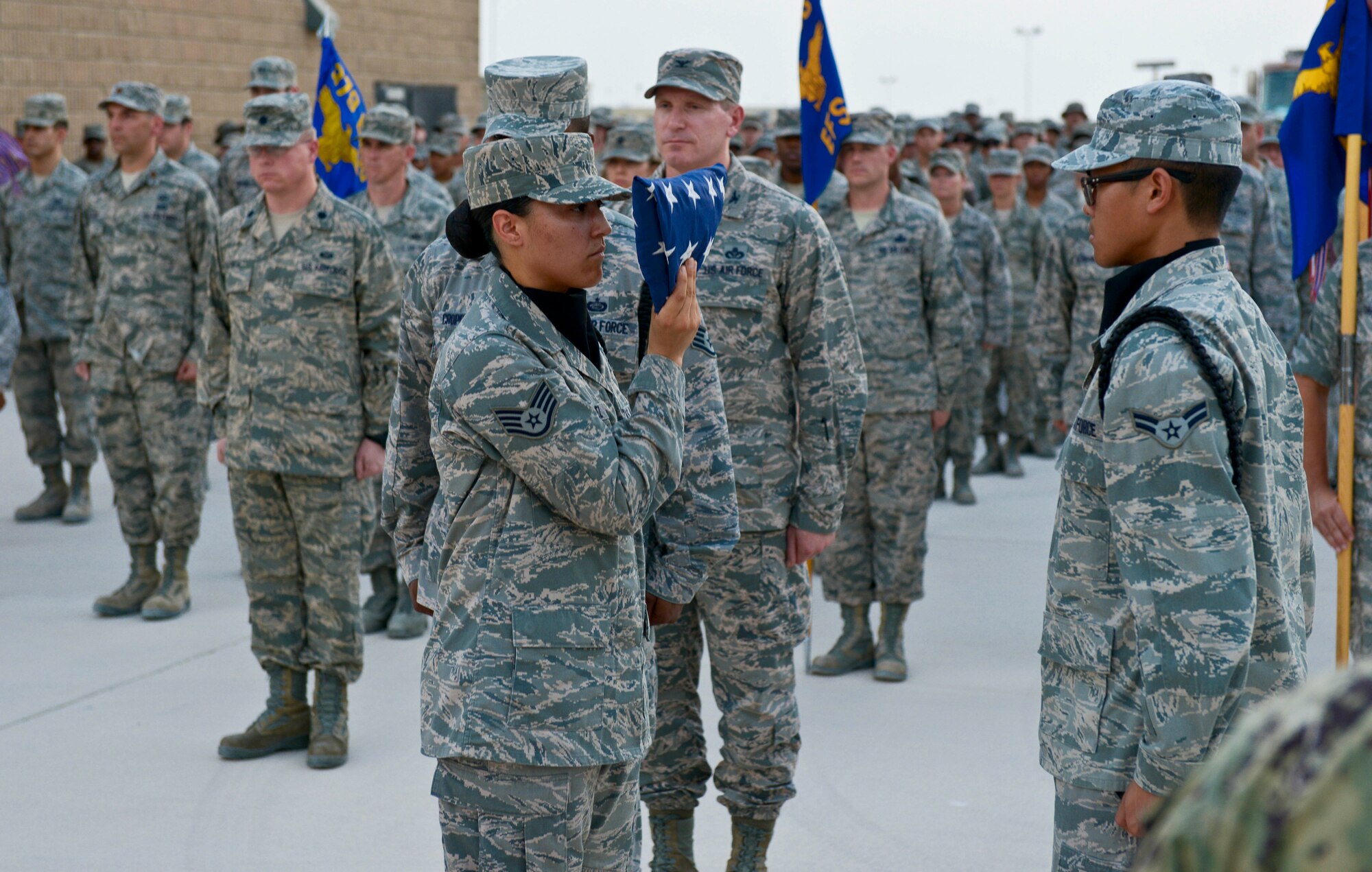 Members of the base honor guard perform flag detail during a 9/11 retreat ceremony at the 379th Air Expeditionary Wing in Southwest Asia, Sept. 11, 2013. The ceremony included a special session where fallen Grand Slam warriors were paid tribute for their ultimate sacrifice in the war on terrorism. The 379th AEW has been a constant in the U.S. Air Forces Central Command's area of responsibility over the last nearly 12 years. (U.S. Air Force photo/Staff Sgt. Benjamin W. Stratton)