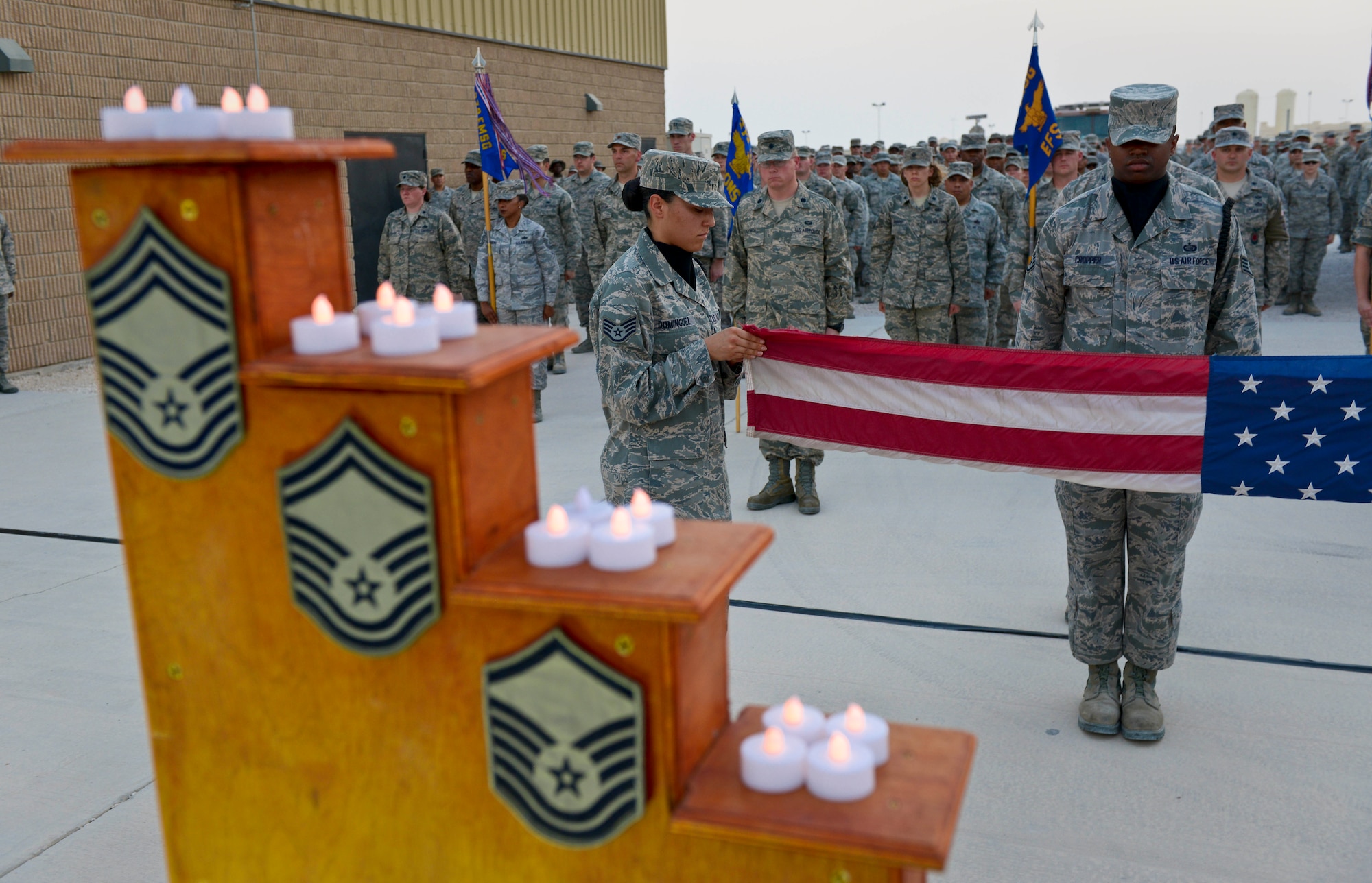 Members of the base honor guard fold the flag during a 9/11 retreat ceremony at the 379th Air Expeditionary Wing in Southwest Asia, Sept. 11, 2013. The ceremony included a special session where fallen Grand Slam warriors were paid tribute for their ultimate sacrifice in the war on terrorism. The 379th AEW has been a constant in the U.S. Air Forces Central Command's area of responsibility over the last nearly 12 years. (U.S. Air Force photo/Staff Sgt. Benjamin W. Stratton)