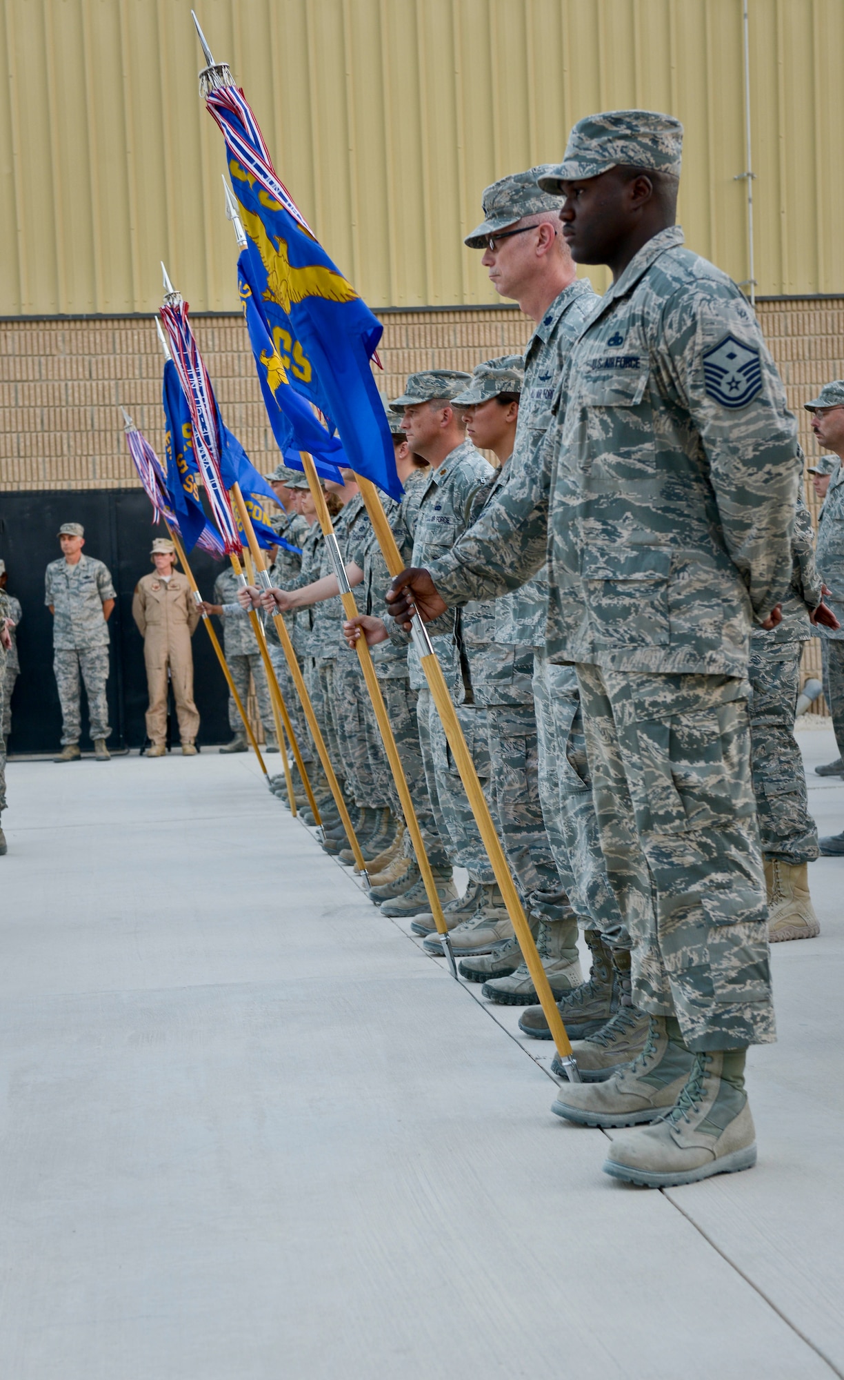 First sergeants and commanders stand at parade rest in reverence to service members who lost their lives in the war on terrorism during a 9/11 retreat ceremony at the 379th Air Expeditionary Wing in Southwest Asia, Sept. 11, 2013. The 379th AEW has been a constant in the U.S. Air Forces Central Command's area of responsibility over the last nearly 12 years. (U.S. Air Force photo/Staff Sgt. Benjamin W. Stratton)