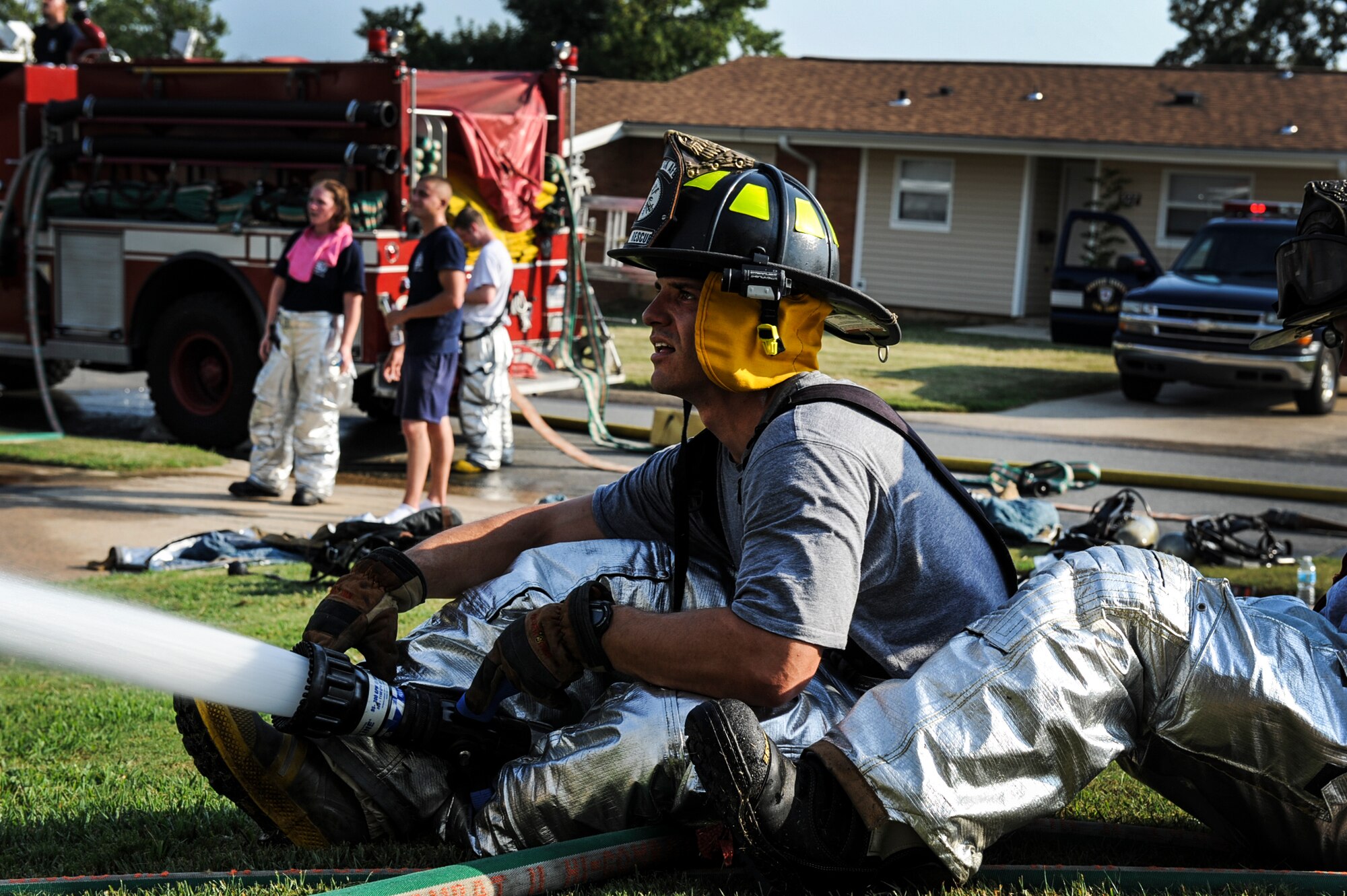 Staff Sgt. Zackary Colburn, a 19th Civil Engineer Squadron firefighter, performs defensive firefighting techniques during a house fire Sept. 7, 2013, at Little Rock Air Force Base, Ark. The Little Rock AFB firefighters are trained to respond to fire alarm activations, vehicle accidents, flightline emergencies and technical rescue situations. (U.S. Air Force photo by Airman 1st Class Cliffton Dolezal)