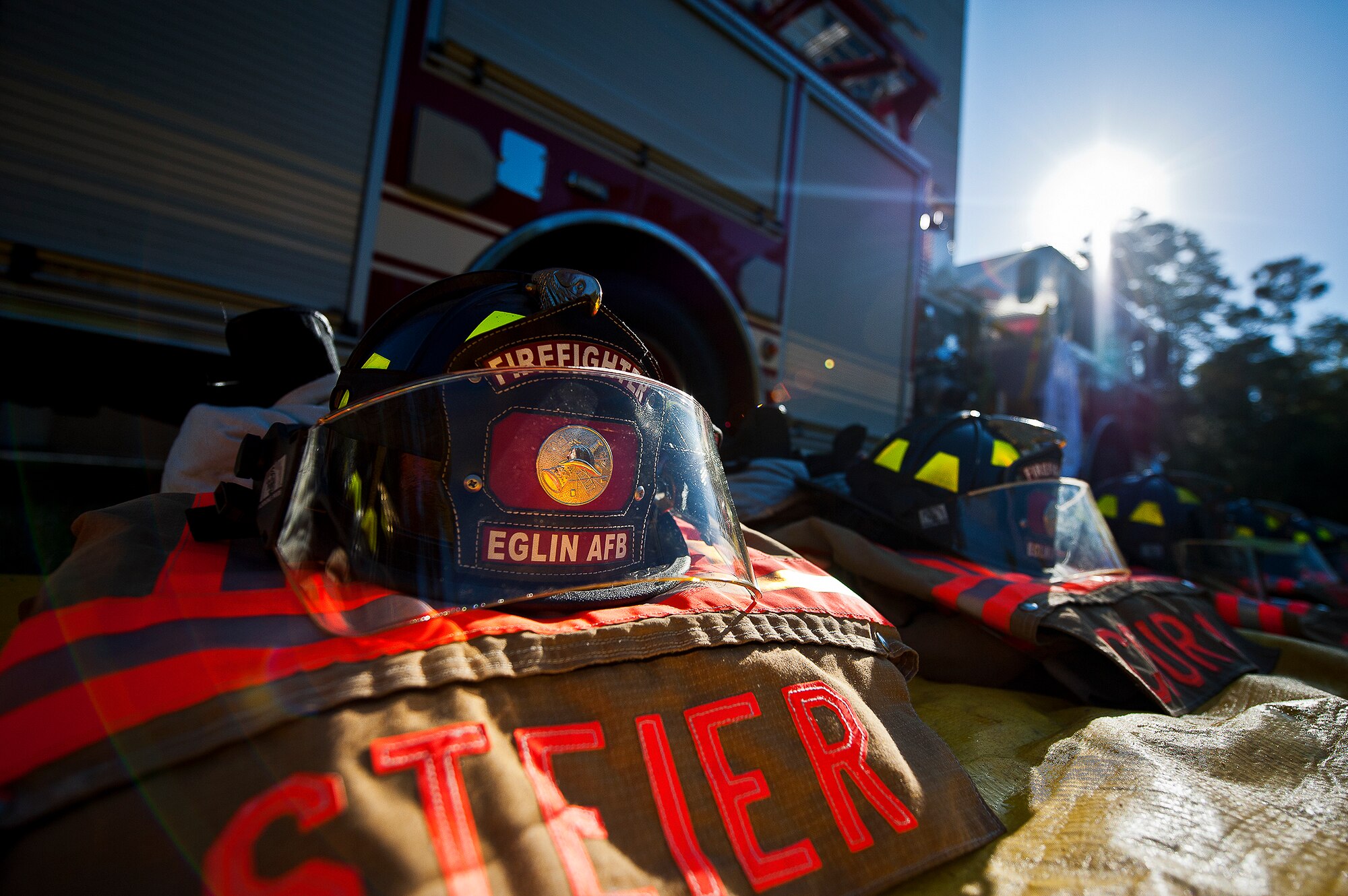 Helmets and gear of the Eglin Air Force Base fire department are aligned in rows prior to their mission Sept. 11.  Fire department Airmen and civilians ascended the 11-story air traffic control tower carrying ribbons with the names of the 343 firefighters killed Sept. 11, 2001. When each name was delivered to the top of the tower it was read aloud.  The event ended on top of the tower with participants hanging the ribbons over the balcony on either side of an American Flag. (U.S. Air Force photo/Samuel King Jr.)