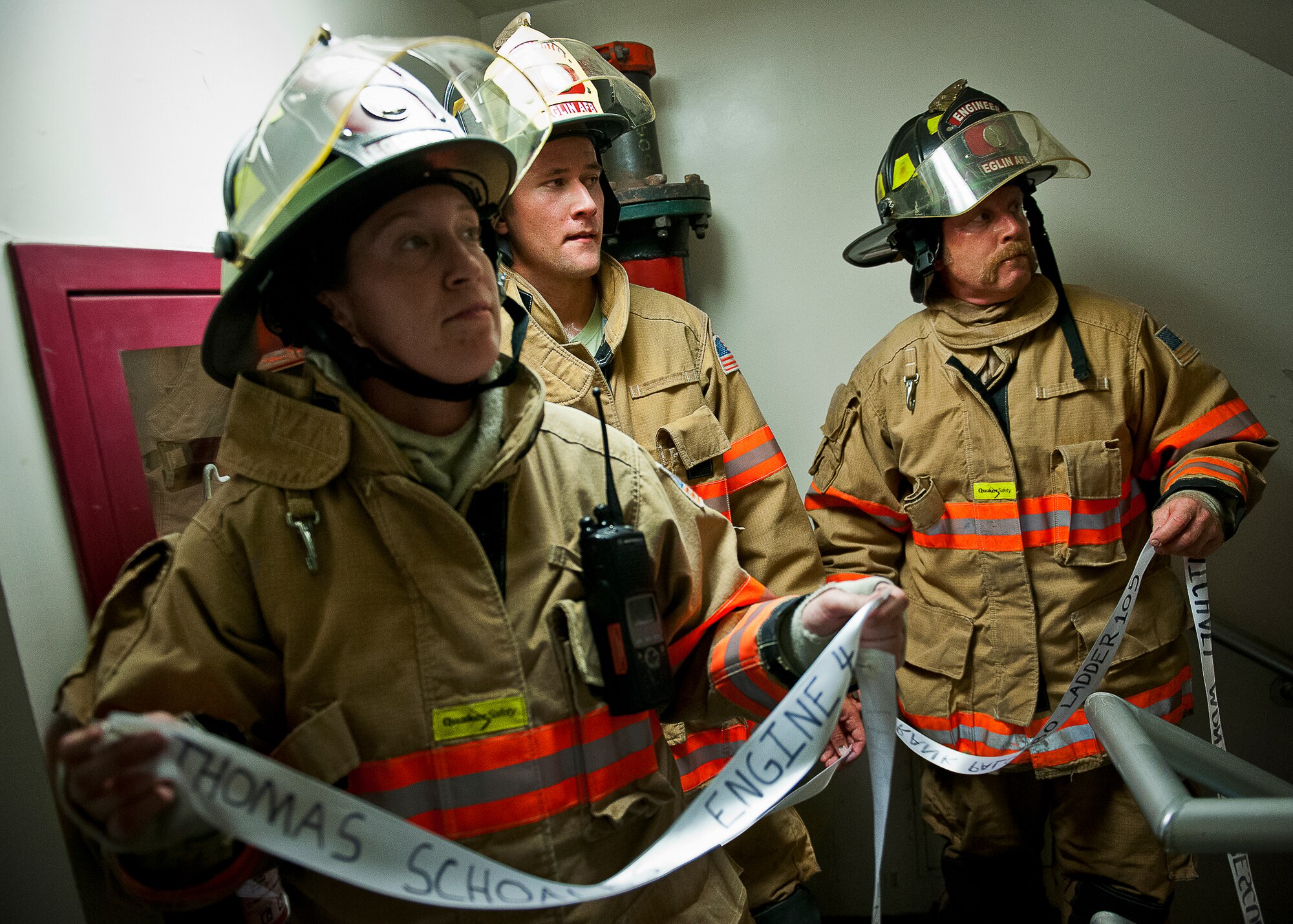 Staff Sgt. Sabrina Nicholson and other Eglin Air Force Base firefighters wait to present their ribbon at the top of the 11-story air traffic control tower Sept. 11.  Fire department Airmen and civilians ascended the tower carrying ribbons with the names of the 343 firefighters killed Sept. 11, 2001. When each name was delivered to the top of the tower it was read aloud.  The event ended on top of the tower with participants hanging the ribbons over the balcony on either side of an American Flag. (U.S. Air Force photo/Samuel King Jr.)