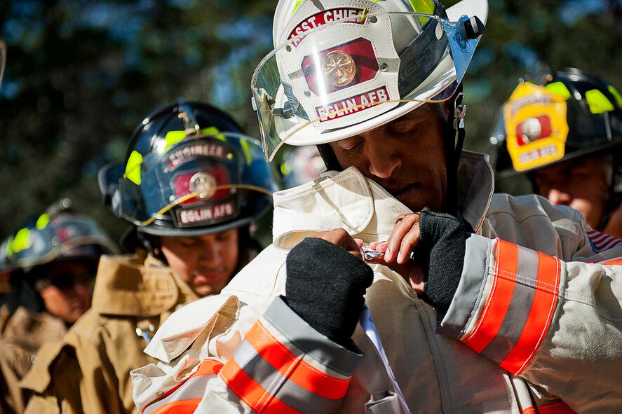 Michael Clayton, the assistant fire chief, pins a ribbon with a name of one of the 343 firefighters killed Sept. 11, 2001 before ascending to the top of the 11-story air traffic control tower Sept. 11 at Eglin Air Force Base, Fla. When each name was delivered to the top of the tower it was read aloud.  The event ended on top of the tower with participants hanging the ribbons over the balcony on either side of an American Flag. (U.S. Air Force photo/Samuel King Jr.)
