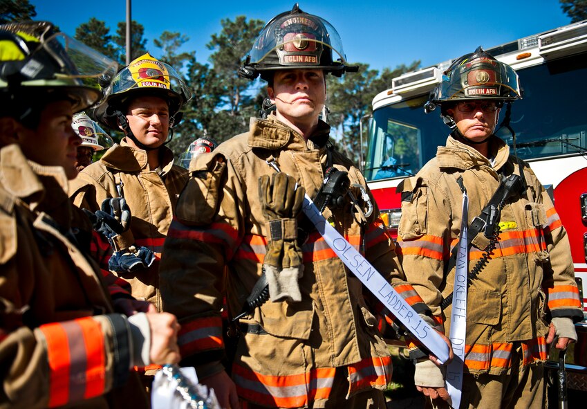 Eglin Air Force Base firefighters attach ribbons with the names of the 343 firefighters killed Sept. 11, 2001 before ascending to the top of the 11-story air traffic control tower Sept. 11. When each name was delivered to the top of the tower it was read aloud.  The event ended on top of the tower with participants hanging the ribbons over the balcony on either side of an American Flag. (U.S. Air Force photo/Samuel King Jr.)