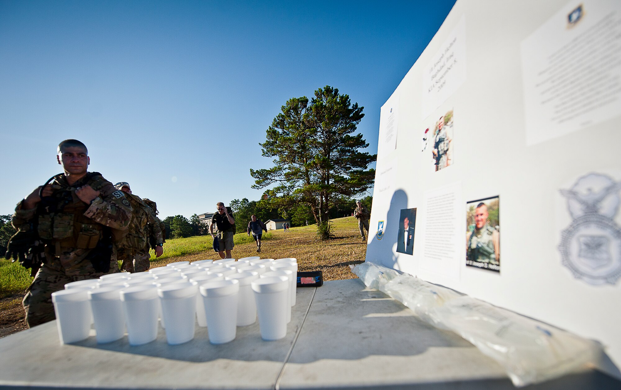 A military member stops to read a display of one of a fallen security forces member during the Fallen Defender Ruck March Sept. 11 at Eglin Air Force Base, Fla.  More than 200 military members and civilians came out to walk or run the 4-mile trail and pay respect to fallen security forces Airmen along the way.  (U.S. Air Force photo/Samuel King Jr.)