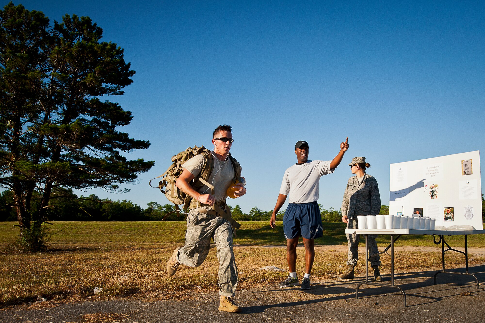 An Airman hustles past the halfway point of the Fallen Defender Ruck March Sept. 11 at Eglin Air Force Base, Fla.  More than 200 military members and civilians came out to walk or run the 4-mile trail and pay respect to fallen security forces Airmen along the way.  (U.S. Air Force photo/Samuel King Jr.)