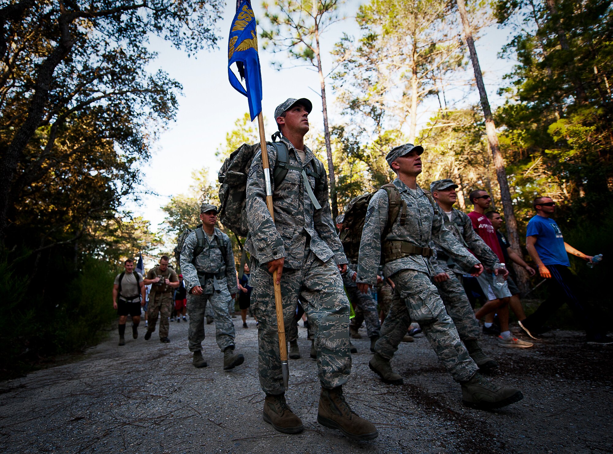 A staff sergeant carries the 96th Mission Support Group guidon during the Fallen Defender Ruck March Sept. 11 at Eglin Air Force Base, Fla.  More than 200 military members and civilians came out to walk or run the 4-mile trail and pay respect to fallen security forces Airmen along the way.  (U.S. Air Force photo/Samuel King Jr.)