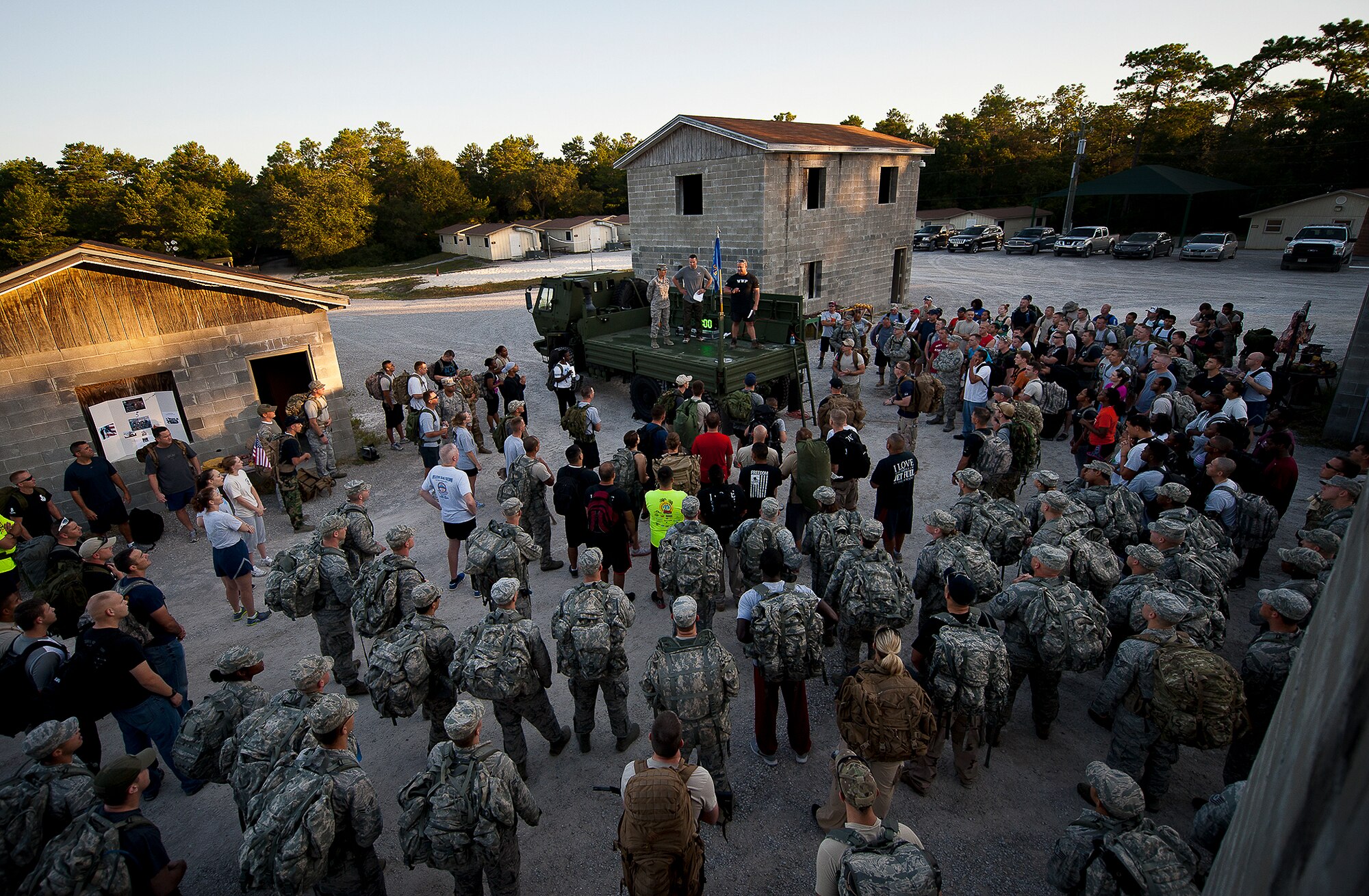 Military members and civilians gather together for a moment of silence prior to the Fallen Defender Ruck March Sept. 11 at Eglin Air Force Base, Fla.  More than 200 people came out to walk or run the 4-mile trail and pay respect to fallen security forces Airmen along the way.  (U.S. Air Force photo/Samuel King Jr.)