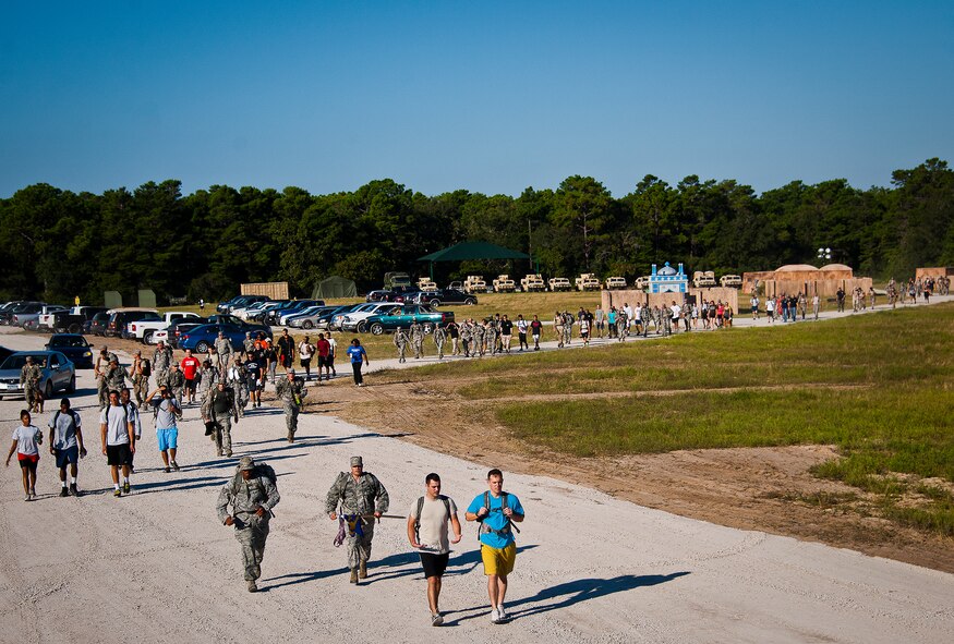 Military members and civilians move toward the finish line of the Fallen Defender Ruck March Sept. 11 at Eglin Air Force Base, Fla.  More than 200 people came out to walk or run the 4-mile trail and pay respect to fallen security forces Airmen along the way.  (U.S. Air Force photo/Samuel King Jr.)