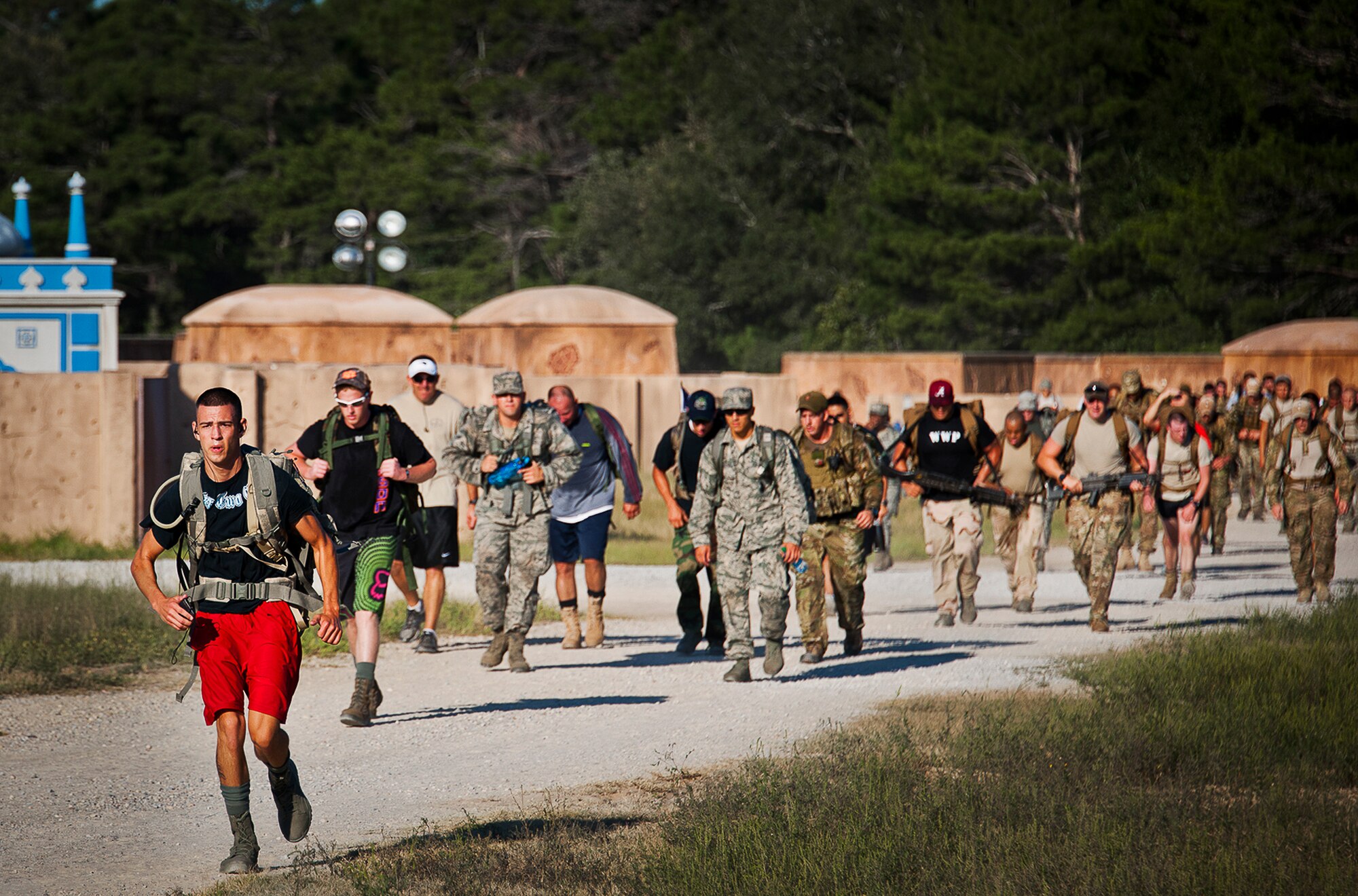 Military members and civilians move toward the finish line of the Fallen Defender Ruck March Sept. 11 at Eglin Air Force Base, Fla.  More than 200 people came out to walk or run the 4-mile trail and pay respect to fallen security forces Airmen along the way.  (U.S. Air Force photo/Samuel King Jr.)
