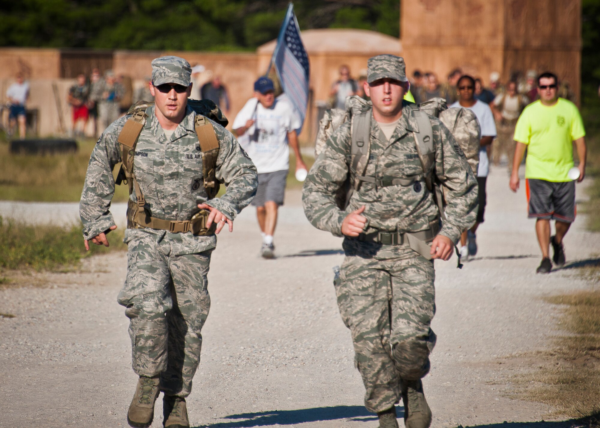 Military members and civilians move toward the finish line of the Fallen Defender Ruck March Sept. 11 at Eglin Air Force Base, Fla.  More than 200 people came out to walk or run the 4-mile trail and pay respect to fallen security forces Airmen along the way.  (U.S. Air Force photo/Samuel King Jr.)