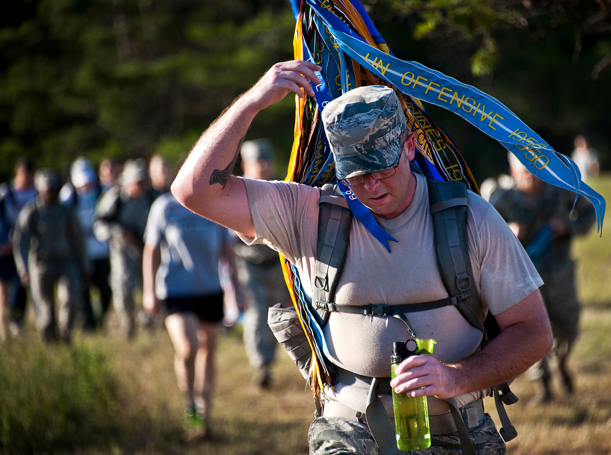 Tech. Sgt. Angus MacIver, carries the 33rd Maintenance Group guidon during the Fallen Defender Ruck March Sept. 11 at Eglin Air Force Base, Fla.  More than 200 military members and civilians came out to walk or run the 4-mile trail and pay respect to fallen security forces Airmen along the way.  (U.S. Air Force photo/Samuel King Jr.)