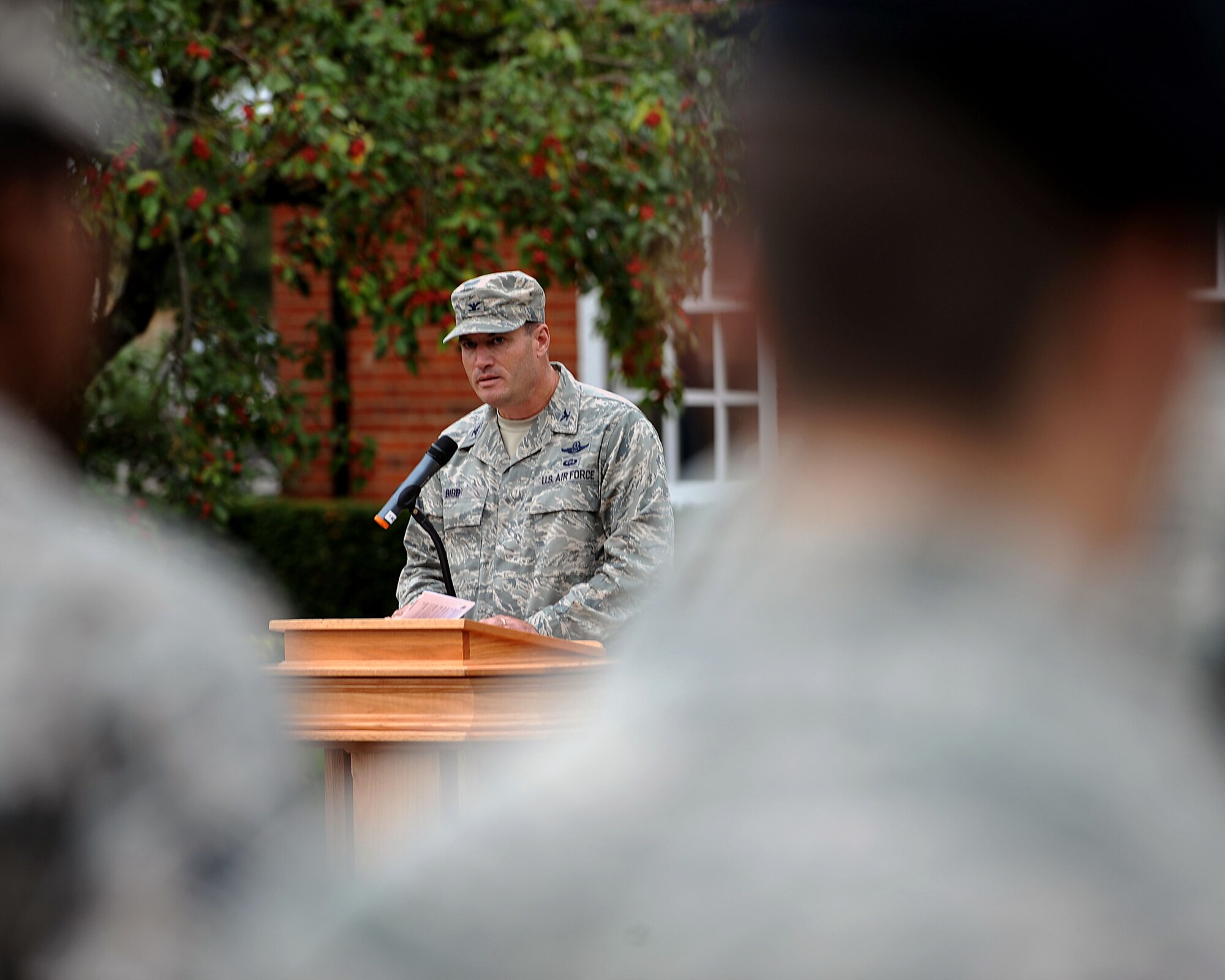 U.S. Air Force Col. Kenneth T. Bibb Jr., 100th Air Refueling Wing commander, speaks to Airmen attending a retreat ceremony Sept. 11, 2013, on RAF Mildenhall, England. Retreat is a long-standing tradition honoring the flag and signaling the end of the duty day. Retreat typically takes place on the last Friday of every month, but RAF Mildenhall held a ceremonial retreat in honor of those who died in the 9/11 attacks. (U.S. Air Force photo by Airman 1st Class Preston Webb/Released)