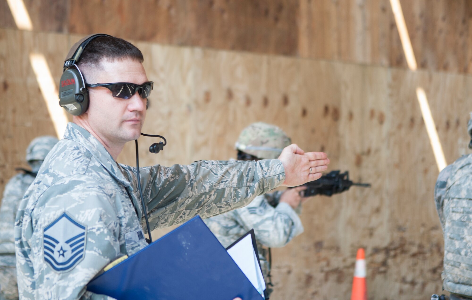 U.S. Air Force Master Sgt. Dale Brown, 23d SFS NCO in charge of training uses a hand gesture to signal it is safe for Airmen to fire their weapons at Moody Air Force Base, Ga., Sept. 6, 2013.  The Airmen had to prove their marksmanship skills to join the base Special Reaction Team. (U.S. Air Force photo by Airman 1st Class Sandra Marrero/Released)

