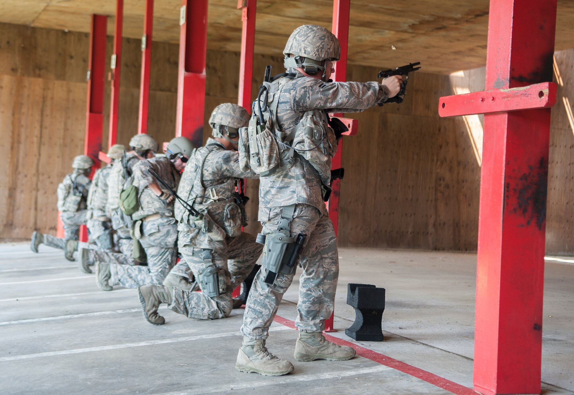 Airmen fire their weapons as part of the marksmanship portion of the Special Reaction Team tryouts at Moody Air Force Base, Ga., Sept. 6, 2013. The SRT hopefuls were evaluated according to the Georgia Special Weapons and Tactics team standards.  
(U.S. Air Force photo by Airman 1st Class Sandra Marrero/Released)
