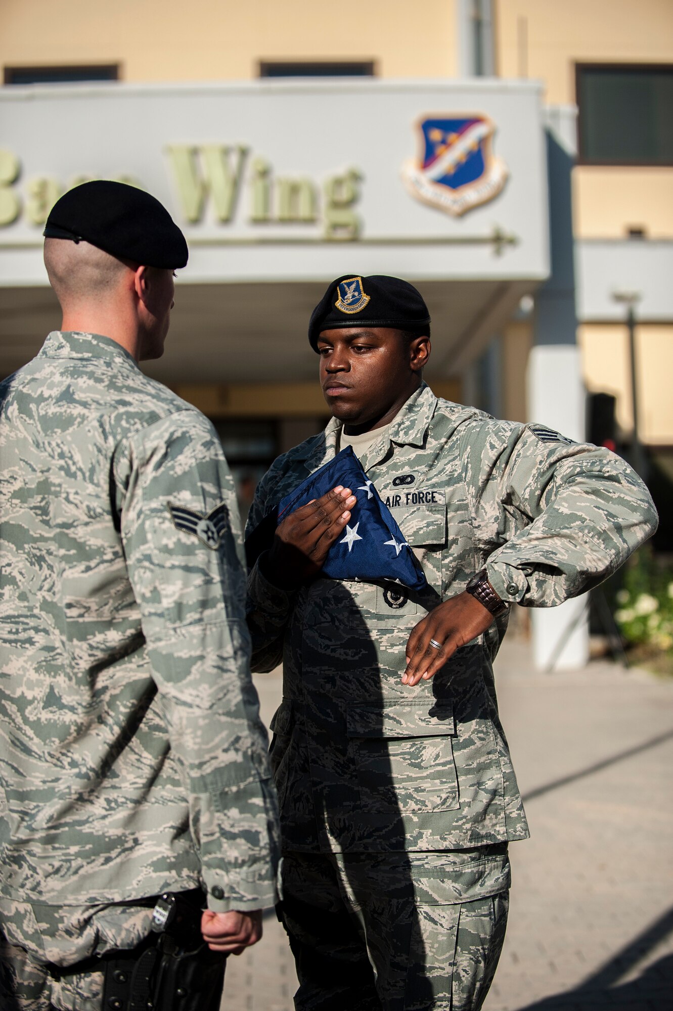 Airmen assigned to the 39th Security Forces Squadron fold the American flag during the 9/11 Retreat Ceremony Sept. 11, 2013, at Incirlik Air Base, Turkey. Airmen from the 39th SFS were chosen to lower the flag to represent the first responders that lost their lives on Sept. 11. (U.S. Air Force photo by Airman 1st Class Nicole Sikorski/Released)