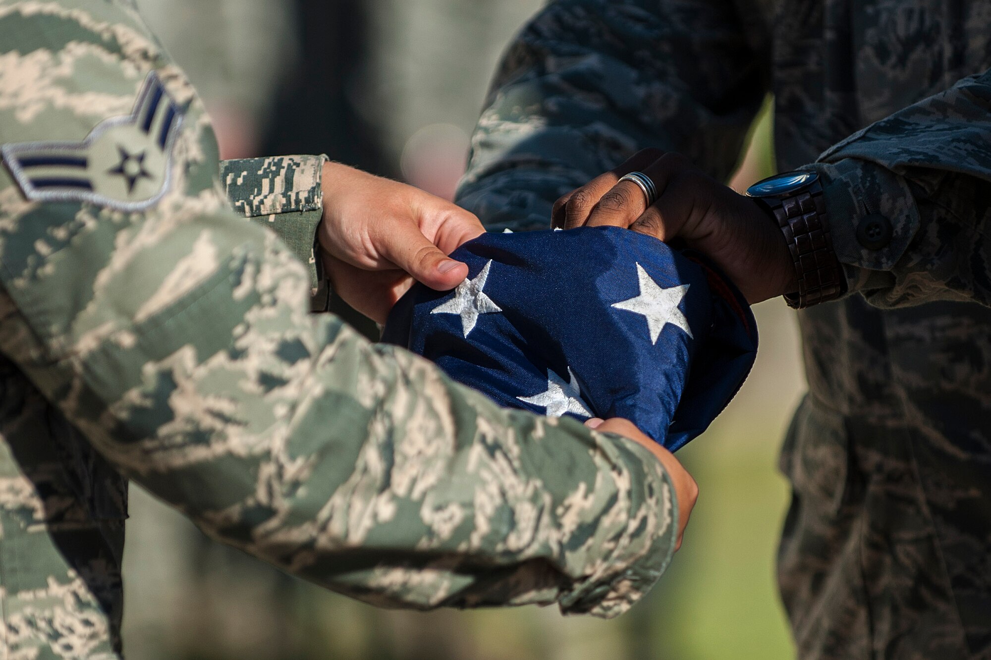 Airmen assigned to the 39th Security Forces Squadron fold the American flag during the 9/11 Retreat Ceremony Sept. 11, 2013, at Incirlik Air Base, Turkey. The retreat was held in remembrance of the victims of the Sept. 11, 2001 terrorist attacks on the United States. (U.S. Air Force photo by Airman 1st Class Nicole Sikorski/Released)
