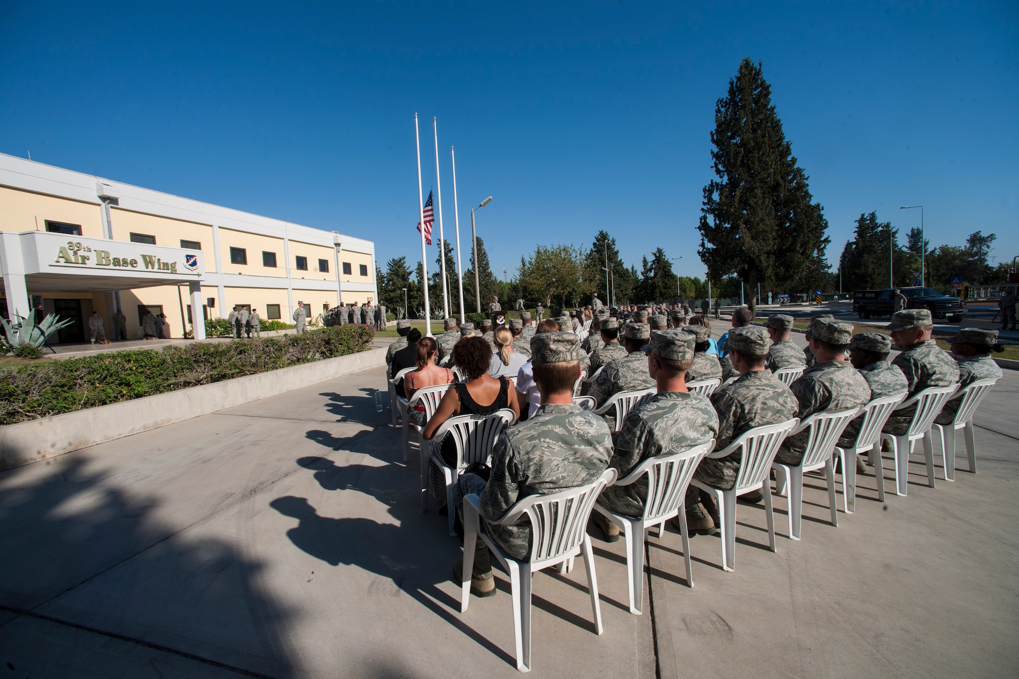 Airmen gather at the 39th Air Base Wing headquarters building for a 9/11 Retreat Ceremony Sept. 11, 2013, at Incirlik Air Base, Turkey. The event included a flag-lowering ceremony in honor of those who lost their lives during the 9/11 terrorist attacks.  (U.S. Air Force photo by Airman 1st Class Nicole Sikorski/Released)