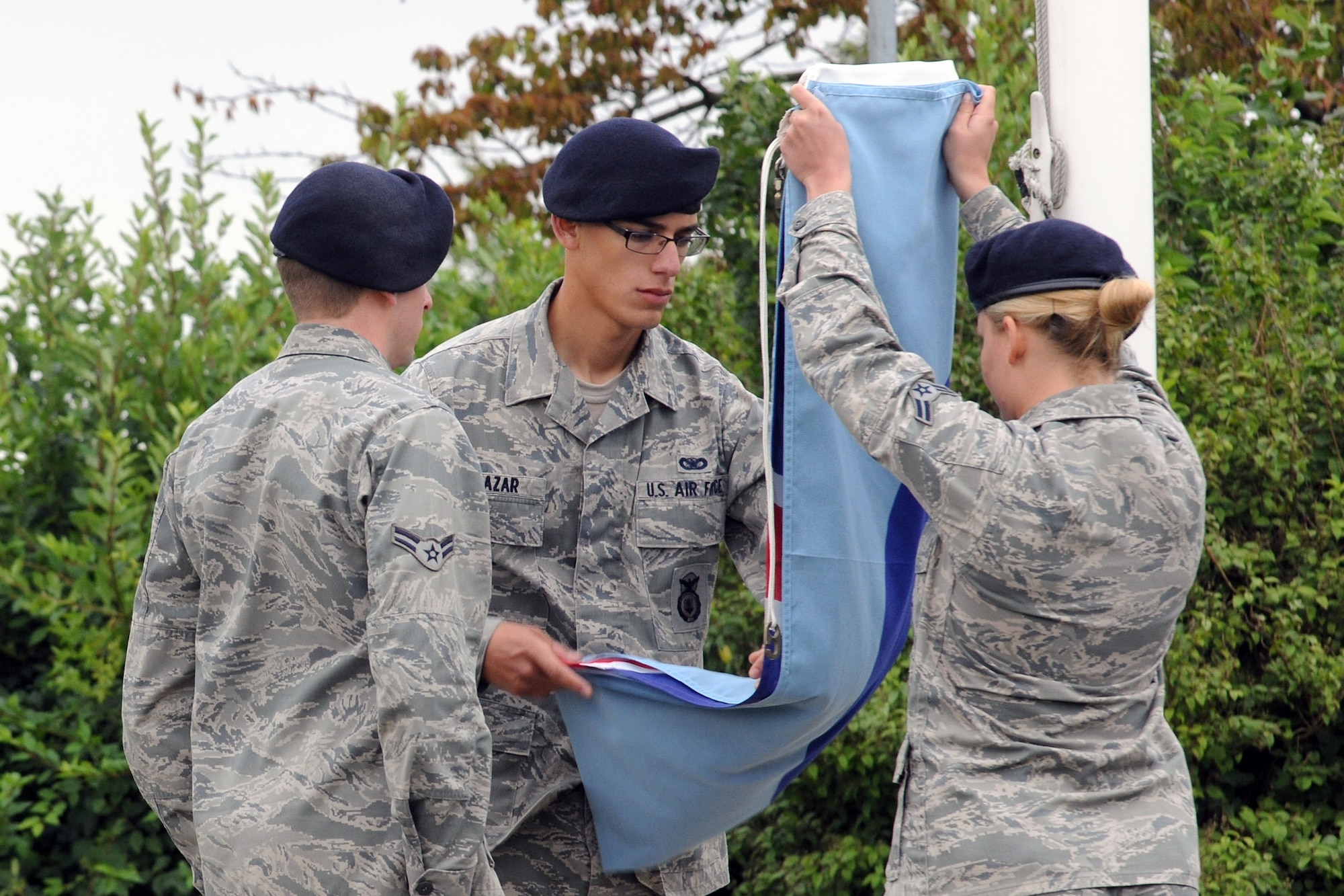 RAF ALCONBURY, United Kingdom – Airman 1st Class Jessica Bennett and Senior Airman Jared Salazar, both from the 423rd Security Forces Squadron, fold the British flag during a retreat at RAF Alconbury Sept. 11. The retreat was held in memory of the 9/11 attacks. (U.S. Air Force photo by Staff Sgt. Brian Stives)