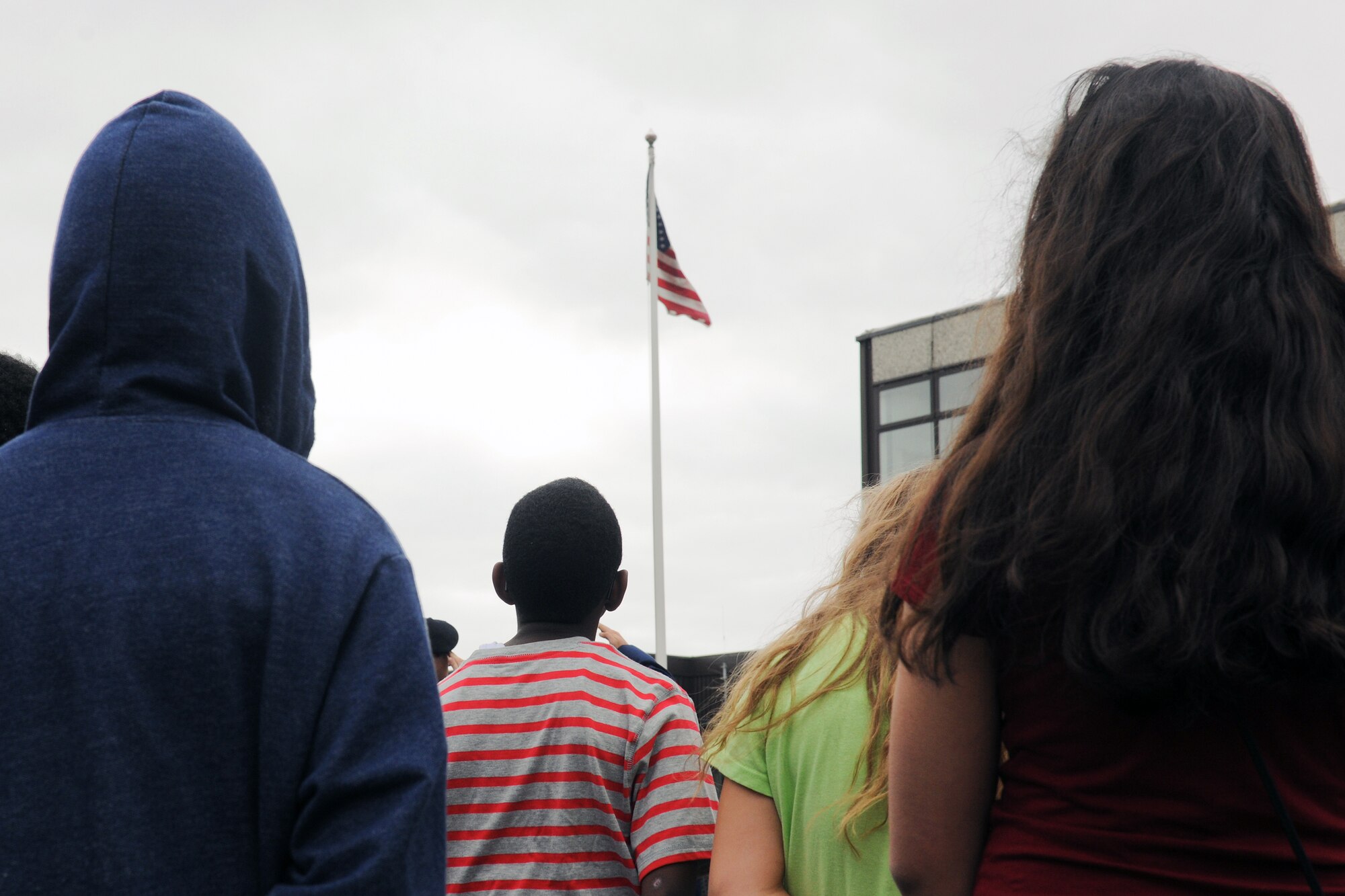 RAF ALCONBURY, United Kingdom – Children from the Alconbury Middle/High School stand at attention during the playing of the U.S. National Anthem during a 9/11 Remembrance Ceremony at the Alconbury Middle/High School Sept. 11. The day marked the twelfth anniversary of the attacks. (U.S. Air Force photo by Staff Sgt. Brian Stives)
