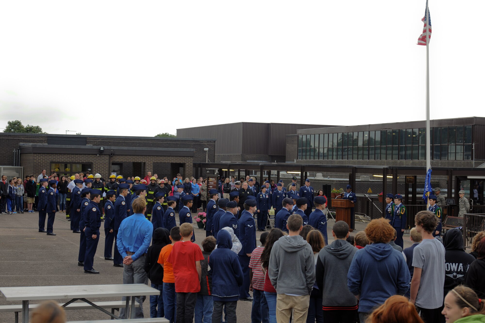 RAF ALCONBURY, United Kingdom – Members of the 501st Combat Support Wing and Alconbury Air Force Junior Reserve Officers' Training Corps stand at attention during the playing of the British National Anthem during a 9/11 Remembrance Ceremony at the Alconbury Middle/High School Sept. 11. The day marked the twelfth anniversary of the attacks. (U.S. Air Force photo by Staff Sgt. Brian Stives)