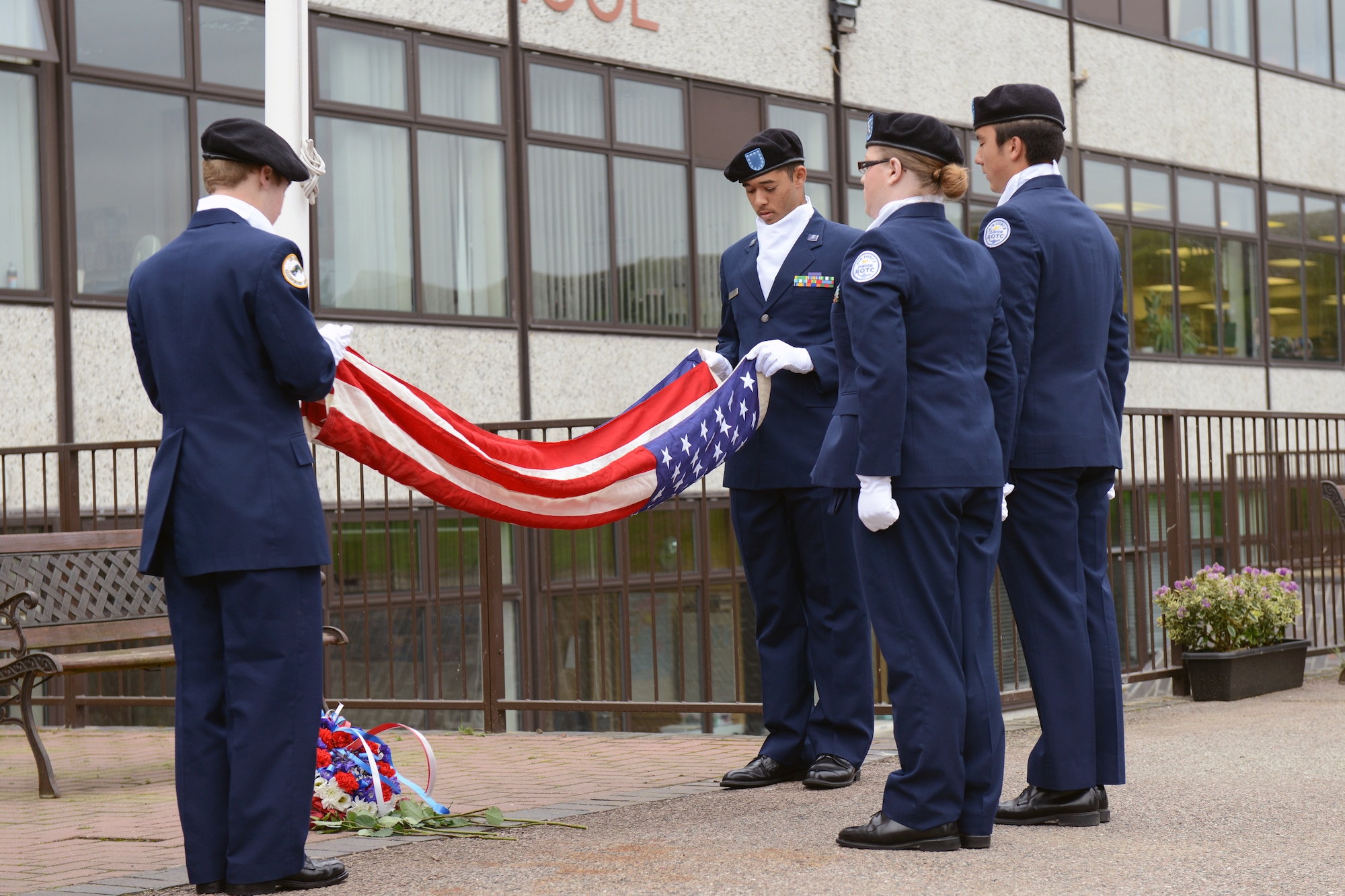 RAF ALCONBURY, United Kingdom – Members of the Alconbury Air Force Junior Reserve Officers' Training Corps fold the U.S. flag during a 9/11 Remembrance Ceremony at the Alconbury Middle/High School Sept. 11. The day marked the twelfth anniversary of the attacks. (U.S. Air Force photo by Tech. Sgt. Chrissy Best)