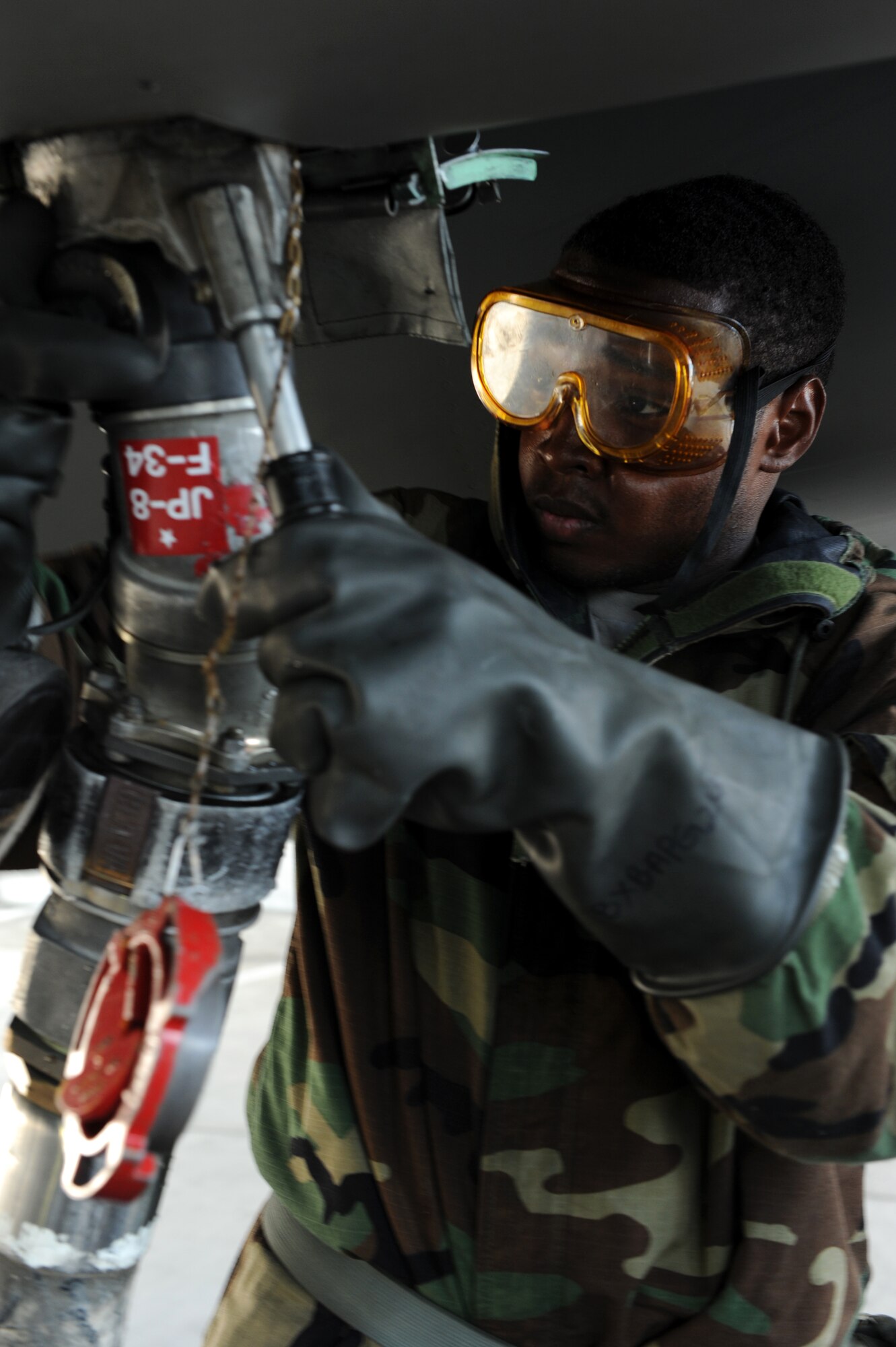 U.S. Air Force Airman 1st Class Fred Rhoe, 44th Aircraft Maintenance Unit crew chief, attaches a fuel line to an F-15 Eagle for a refuel during a local operational readiness exercise on Kadena Air Base, Japan, Sept. 12, 2013. The 18th Wing periodically conducts LOREs to maintain proficiency in their capabilities to support the common defense of the Asia-Pacific region. (U.S. Air Force photo by Airman 1st Class Hailey R. Davis)