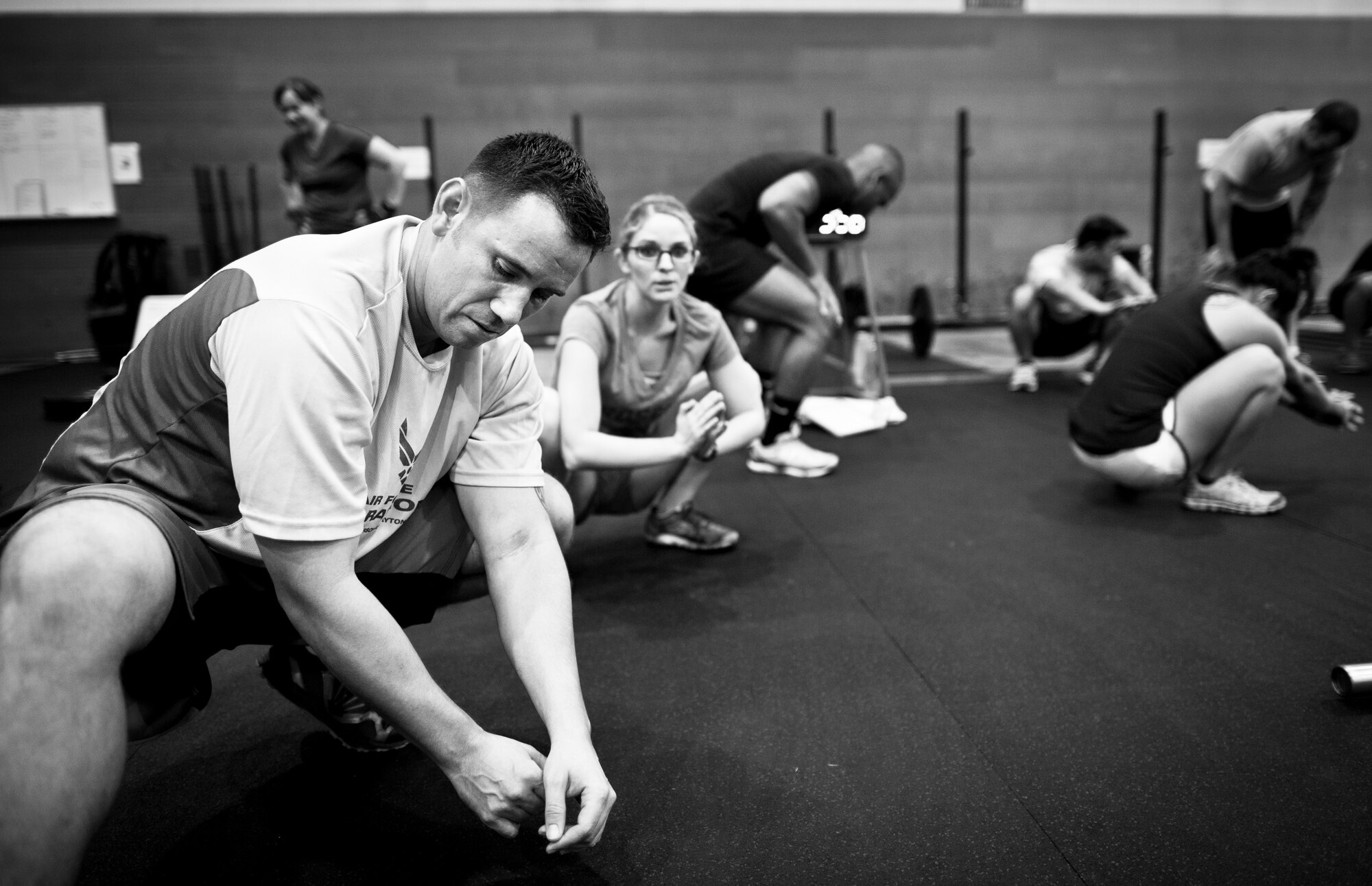 YOKOTA AIR BASE, Japan -- Tech. Sgt. Tyler Masters, American Forces Network, stretches during a tactical fitness training class Sept. 11, 2013, held in the Samurai Fitness Center at Yokota Air Base, Japan. The one-hour class is held during lunchtime to help incorporate fitness into participant’s workday. Combat fitness focus on a CrossFit style type of workout combining strength training and endurance for a well-balanced all over body workout. (U.S. Air Force photo by Staff Sgt. Stacy Moless)       