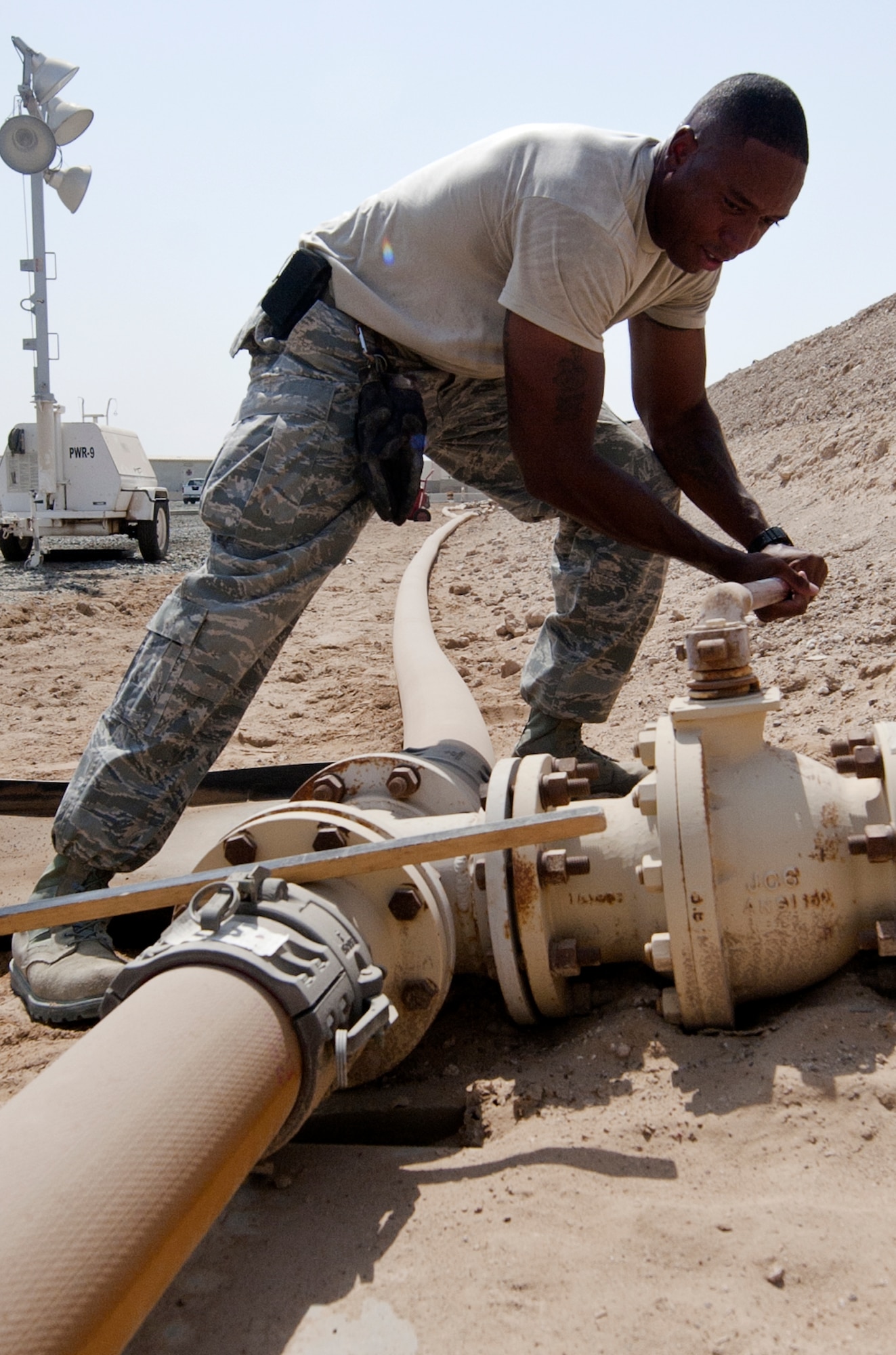 U.S. Air Force Staff Sgt. Joseph Lima, 380th Expeditionary Logistics Readiness Squadron fuels bulk storage supervisor, shuts off a valve that leads to a fuel bladder at an undisclosed location in Southwest Asia Sept. 3, 2013. As the supervisor, or ‘Yard Boss’, Lima is responsible for every fuel bladder and the fuel lines leading to them. Lima calls Bridgeport, Conn., home and is deployed from Minot Air Force Base, N.D. (U.S. Air Force photo by Staff Sgt. Jacob Morgan) 