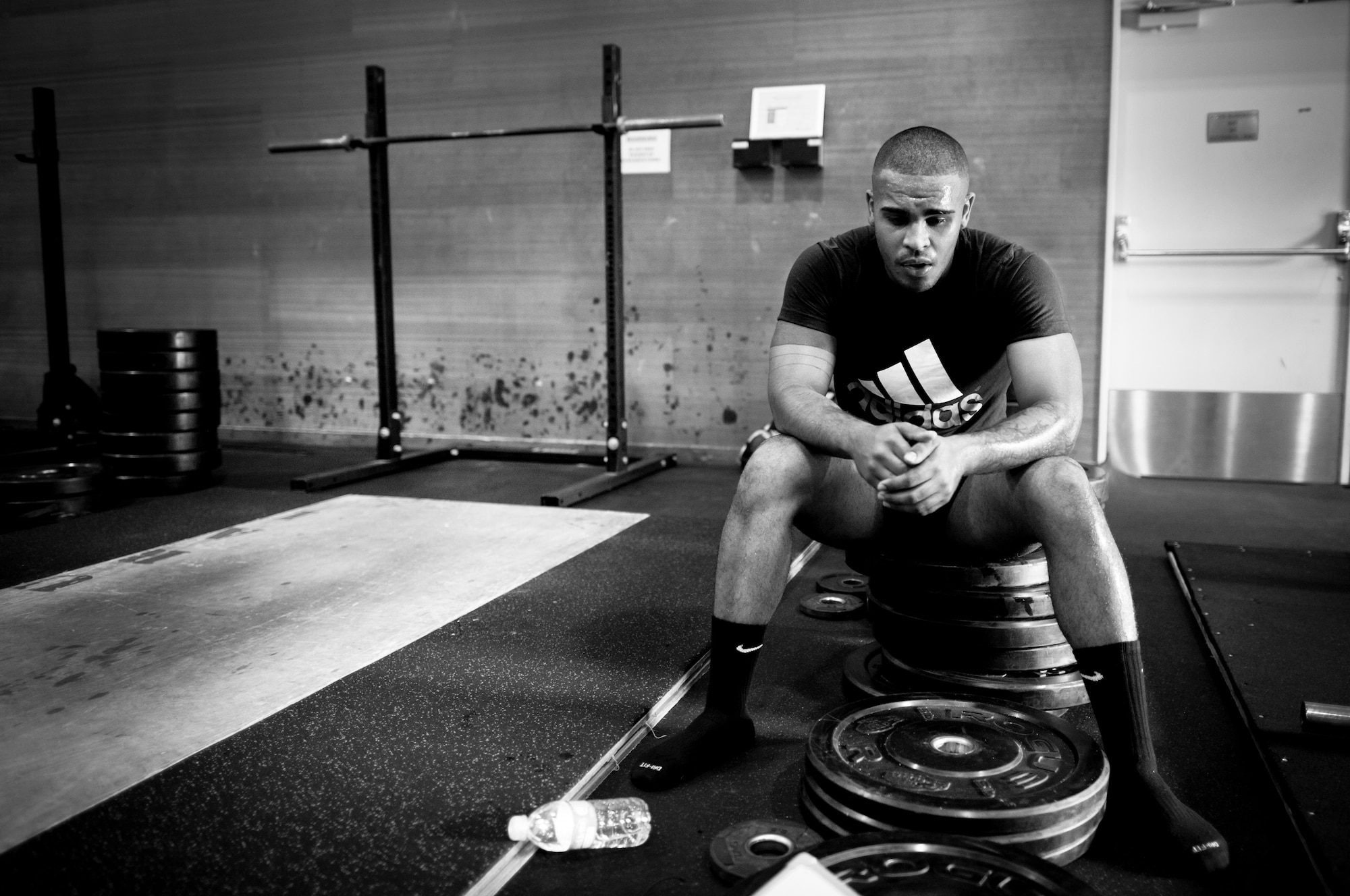 YOKOTA AIR BASE, Japan -- Airman 1st Class Mathew Depena, 374th Force Support Squadron, rests after a tactical fitness training class Sept. 11, 2013, at Yokota Air Base, Japan. The class, held at the Samurai Fitness Center, is held Monday, Wednesday and Fridays from 11:30 a.m. to 12:30 p.m. in the Samurai Fitness Center. Tactical fitness is a CrossFit style type of workout combining strength training and endurance for a well-balanced all over body workout. (U.S. Air Force photo by Staff Sgt. Stacy Moless)       
