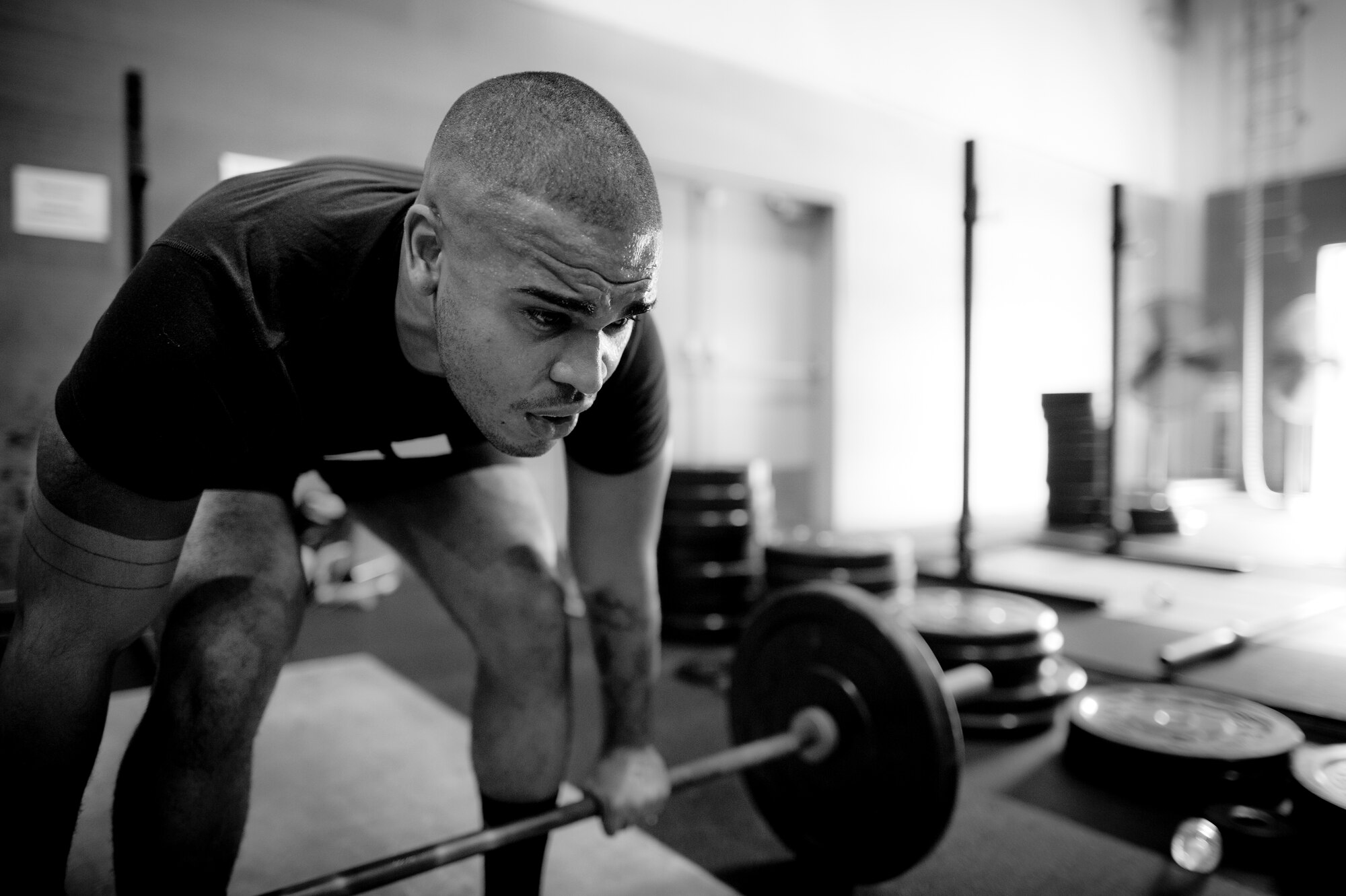 YOKOTA AIR BASE, Japan-- Airman 1st Class Mathew Depena, 374th Force Support Squadron, sets up for a thruster during a tactical fitness training class Sept. 11, 2013, held in the Samurai Fitness Center at Yokota Air Base, Japan. The class is held at lunchtime, helping people squeeze fitness into their workday. Tactical fitness is a CrossFit style type of workout focused on combining strength training and endurance for a well-balanced all over body workout. The instructors stress proper form teaching students how to safely lift, helping to minimize workout related injuries. (U.S. Air Force photo by Staff Sgt. Stacy Moless)         