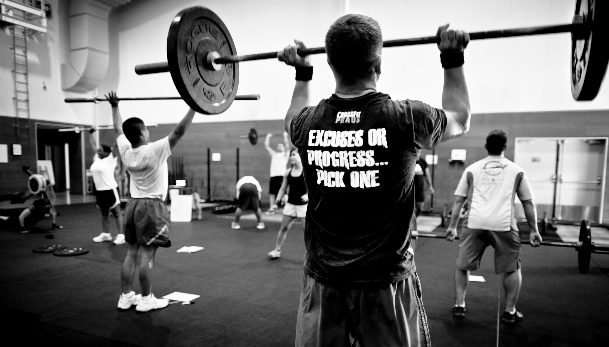 YOKOTA AIR BASE, Japan-- Instructor Wes Herche, completes a thruster during a tactical fitness training class Sept. 11, 2013, at Yokota Air Base, Japan. The class is held Monday, Wednesday and Fridays from 11:30 a.m. to 12:30 p.m. in the Samurai Fitness Center. Combat fitness is a CrossFit style type of workout combining strength training and endurance for a well-balanced all over body workout. The instructors stress proper form teaching students how to safely lift, helping to minimize workout related injuries. (U.S. Air Force photo by Staff Sgt. Stacy Moless)       