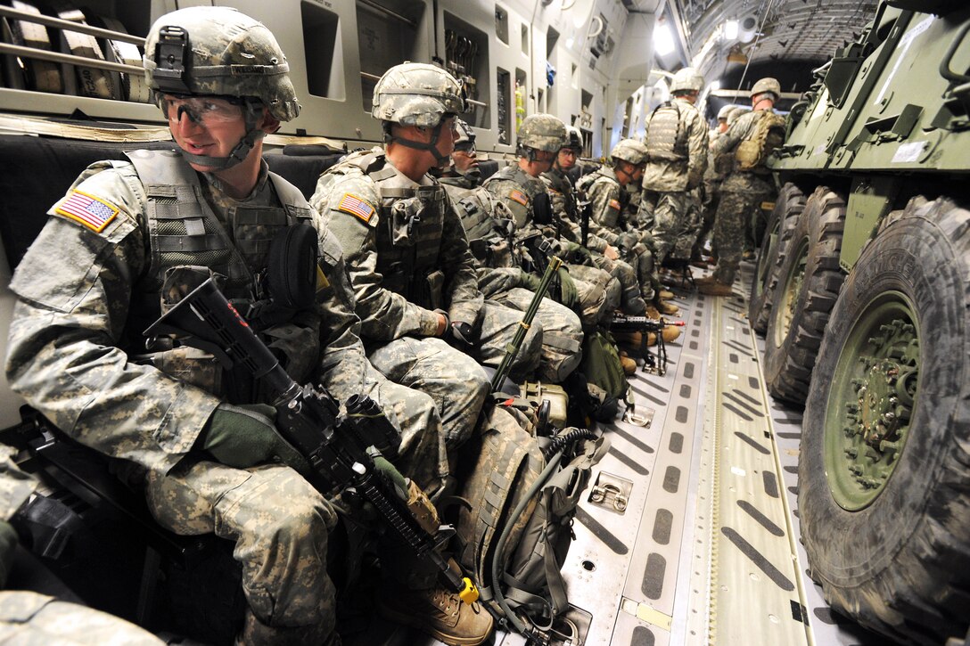 Army Pvt. Joshua Williams, left, and fellow soldiers prepare to off-load on Joint Base Elmendorf-Richardson, Alaska, Sept. 10, 2013. Williams is assigned to the 1st Stryker Brigade Combat Team, 3rd Battalion, 21st Infantry Regiment.