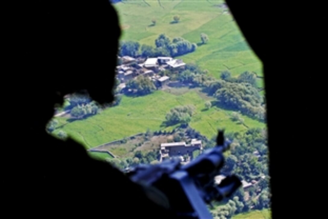 U.S. Army Sgt. Steve Lafond mans his machine gun inside a UH-60 Black Hawk helicopter over Jalalabad, Afghanistan, Sept. 10, 2013. Lafond, a crew chief, is assigned to the 3rd Battalion General Support, 10th Combat Aviation Brigade.