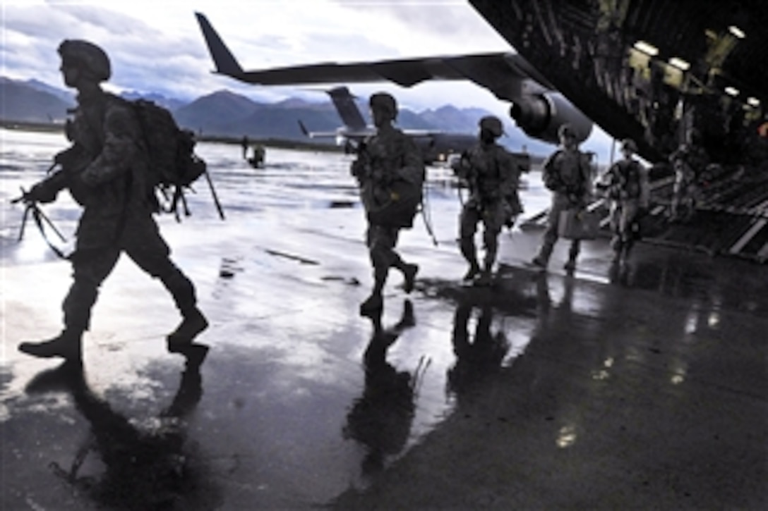 Soldiers exit a U.S. Air Force C-17 Globemaster III aircraft on Joint Base Elmendorf-Richardson, Alaska, Sept. 10, 2013. The soldiers are assigned to the 1st Stryker Brigade Combat Team, 3rd Battalion, 21st Infantry Regiment.