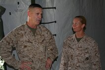 Col. Edmund J. Bowen, Left, and Capt. Rebecca L. Wilkinson discuss the success of the field mess Aug. 21, at Camp Kinser during exercise Ulichi Freedom Guardian 2013. Marines from Food Services set up a field mess during the exercise to demonstrate their capabilities in a field environment in the event of combat operations. Bowen is the commanding officer of Combat Logistics Regiment 37, 3rd Marine Logistics Group, III Marine Expeditionary Force. Wilkinson is the commanding officer of Company F, Combat Logistic Battalion 31, CLR-37, 3rd MLG, III MEF. 