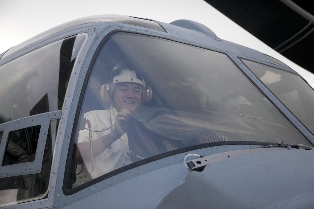 A member of the Liberal Democratic Party of Japan sits in the cockpit of an MV-22B Osprey Sept. 9 at Marine Corps Air Station Futenma. During the LDP’s visit to the station, the delegation was able to get a close-up look of the Osprey and learn about the aircraft’s capabilities. The Osprey is with Marine Medium Tiltrotor Squadron 262, Marine Aircraft Group 36, 1st Marine Aircraft Wing, III Marine Expeditionary Force. 
