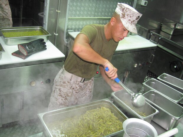 Lance Cpl. Belly T. Vang prepares vegetables to serve for lunch at a field mess Aug. 21 at Camp Kinser during exercise Ulichi Freedom Guardian 2013. The field mess was set up in conjunction with the exercise to compete for Major General W.P.T. Hill award. Vang is a food service specialist with Combat Logistics Regiment 37, 3rd Marine Logistics Group, III Marine Expeditionary Force. 