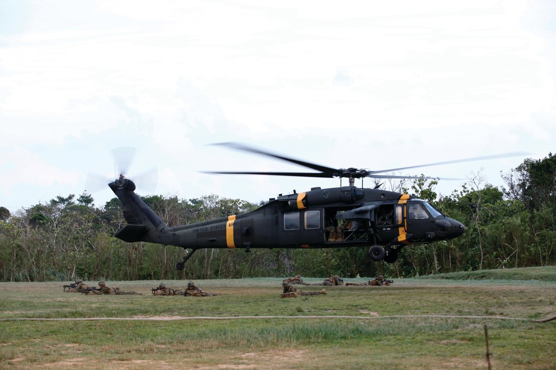 Marines secure a landing zone as an Army UH-60 Black Hawk helicopter takes flight Sept. 10 at Landing Zone Phoenix on Camp Schwab. Three helicopters with the Army’s 2nd Combat Aviation Brigade were used for Marine Wing Support Squadron 172’s forward-arming and refueling point training during Exercise Lejeune II. MWSS-172 is with Marine Aircraft Group 36, 1st Marine Aircraft Wing, III Marine Expeditionary Force.
