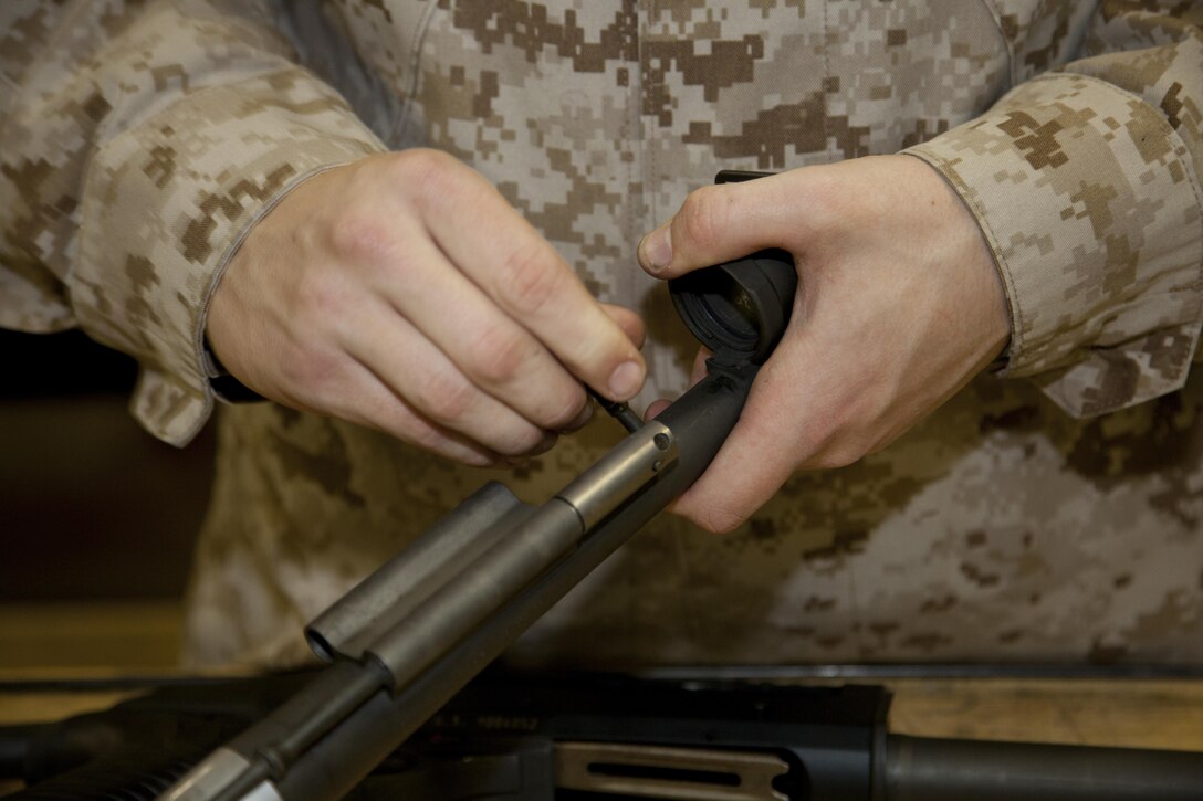 Cpl. Shields L. Woods removes the gas piston from an M1014 semi-automatic shotgun April 22 at the armory on Camp Foster. “I like the maintenance,” said Woods. “When we get a weapon that’s broken and figure out what is wrong with it, it is like solving a mystery.” Woods is a small-arms repairer and technician with Headquarters and Service Battalion, Marine Corps Base Camp Smedley D. Butler, Marine Corps Installations Pacific. 