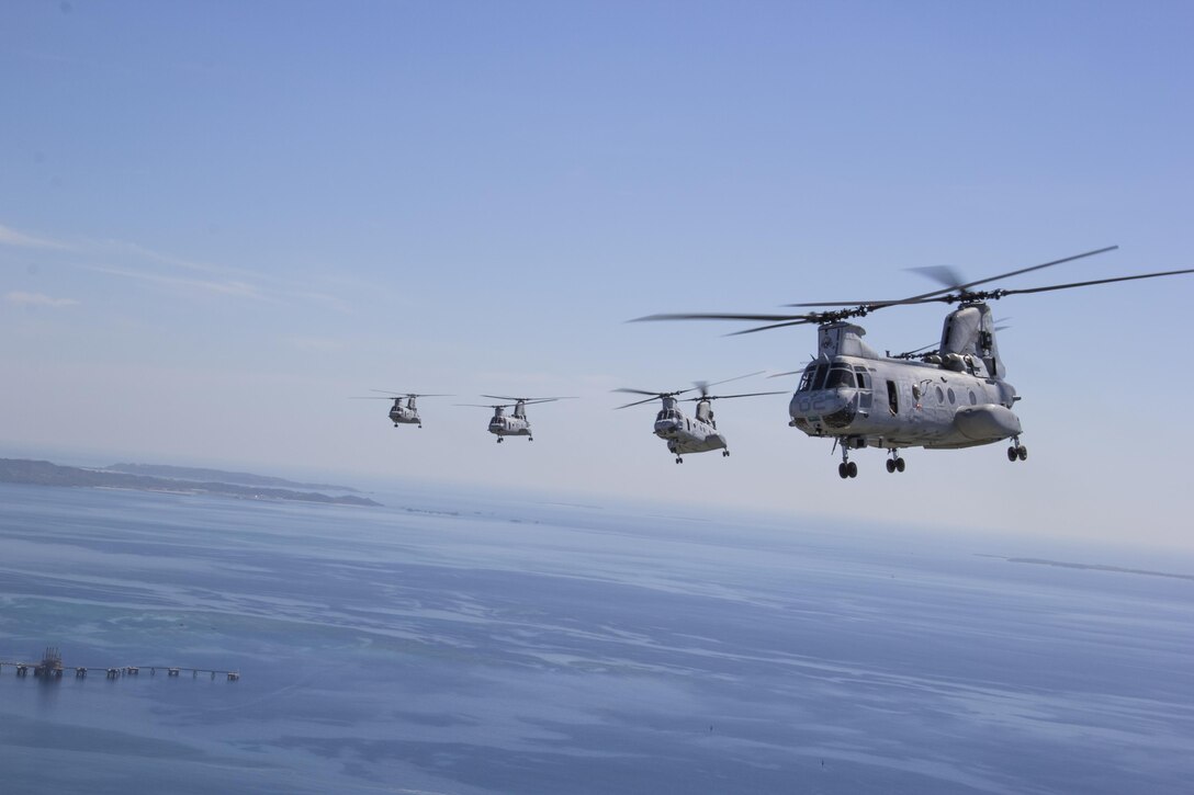 CH-46E Sea Knight helicopters fly in formation during a sundown flight over Okinawa Sept. 6 to commemorate the retiring aircraft. Marine Medium Tiltrotor Squadron 262 is slated to hold their final flight of CH-46Es Sept. 30, as they fly down to Camp Kinser to be retired. 