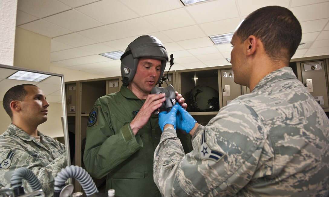 Airman 1st Class Michael Diaz, 4th Special Operations Squadron aircrew flight equipment technician, fits Acting Secretary of the Air Force Eric Fanning’s oxygen mask prior to flying on a CV-22 Osprey and AC-130U Spooky at Hurlburt Field Fla., Sept. 9, 2013. The visit is part of Fanning’s familiarization with various Air Force missions since becoming the acting secretary. 
