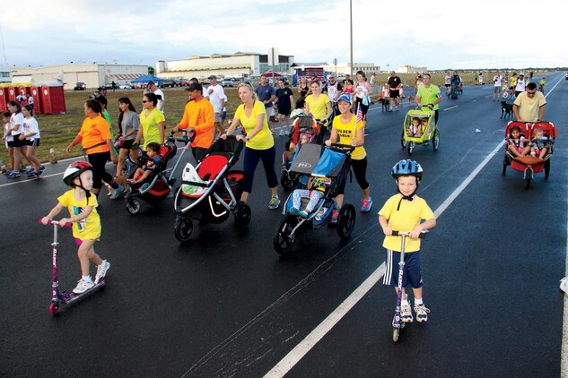 Participants in the Tripler Fisher House 8K Hero and Remembrance Run, Walk or Roll 2013 headdown the road at Ford Island, Pearl Harbor during the race, Sept. 7, 2013. The run annually commemorates fallen service members from each branch of the military. (Photo courtesy of David Livingston)