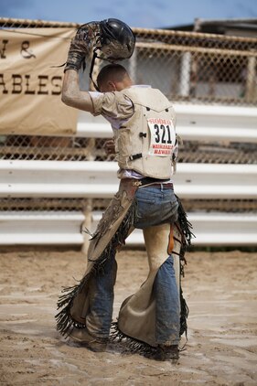 John McDonald, a competitor in a bull riding competition, walks out of the ring after being knocked off early by his bull, Ele Ele, during the inaugural Surf & Turf Buck & Bull Event & Concert at the New Town & Country Stables in Waimanalo, Hawaii, Sept. 7, 2013. (U.S. Marine Corps photo by Lance Cpl. Matthew Bragg)
