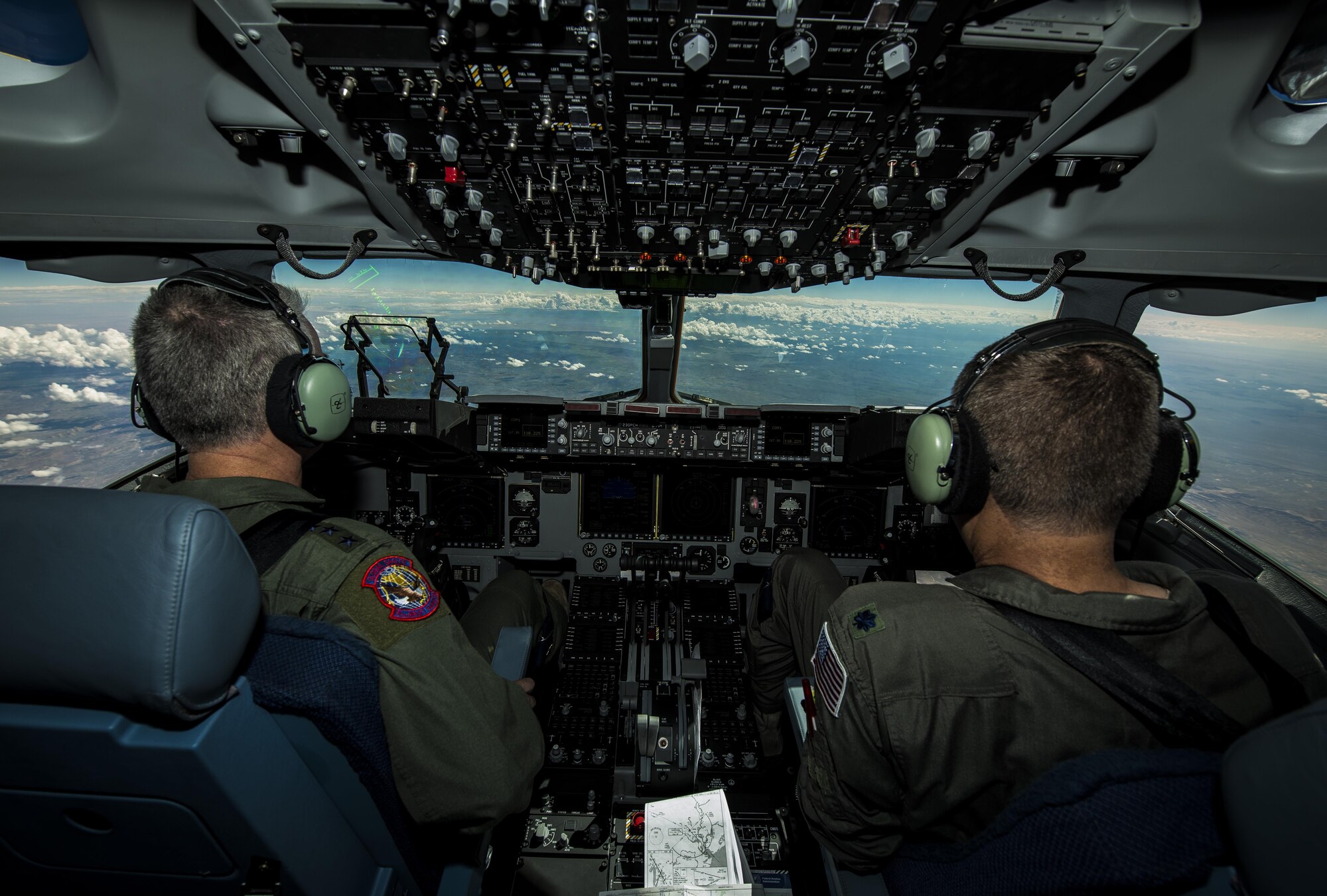 General Paul Selva, Air Mobility Command commander, takes control of C-17 Globemaster III, P-223, mid-flight during the inaugural flight of the final U.S. Air Force C-17 Sept. 12, 2013. Lt. Gen. James Jackson, Air Force Reserve commander, performed the take-off from California and Lt. Gen. Stanley Clarke, Air National Guard director, landed the aircraft at Joint Base Charleston, S.C.